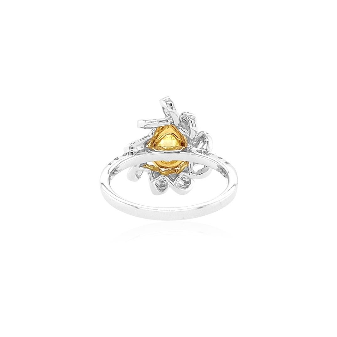 This cocktail Platinum ring features a vibrant natural Intense Yellow Diamond at its centre, accentuated by a halo of Yellow Diamonds and delicate White Diamonds. A perfect statement piece, this pretty ring will add a touch of elegance to any
