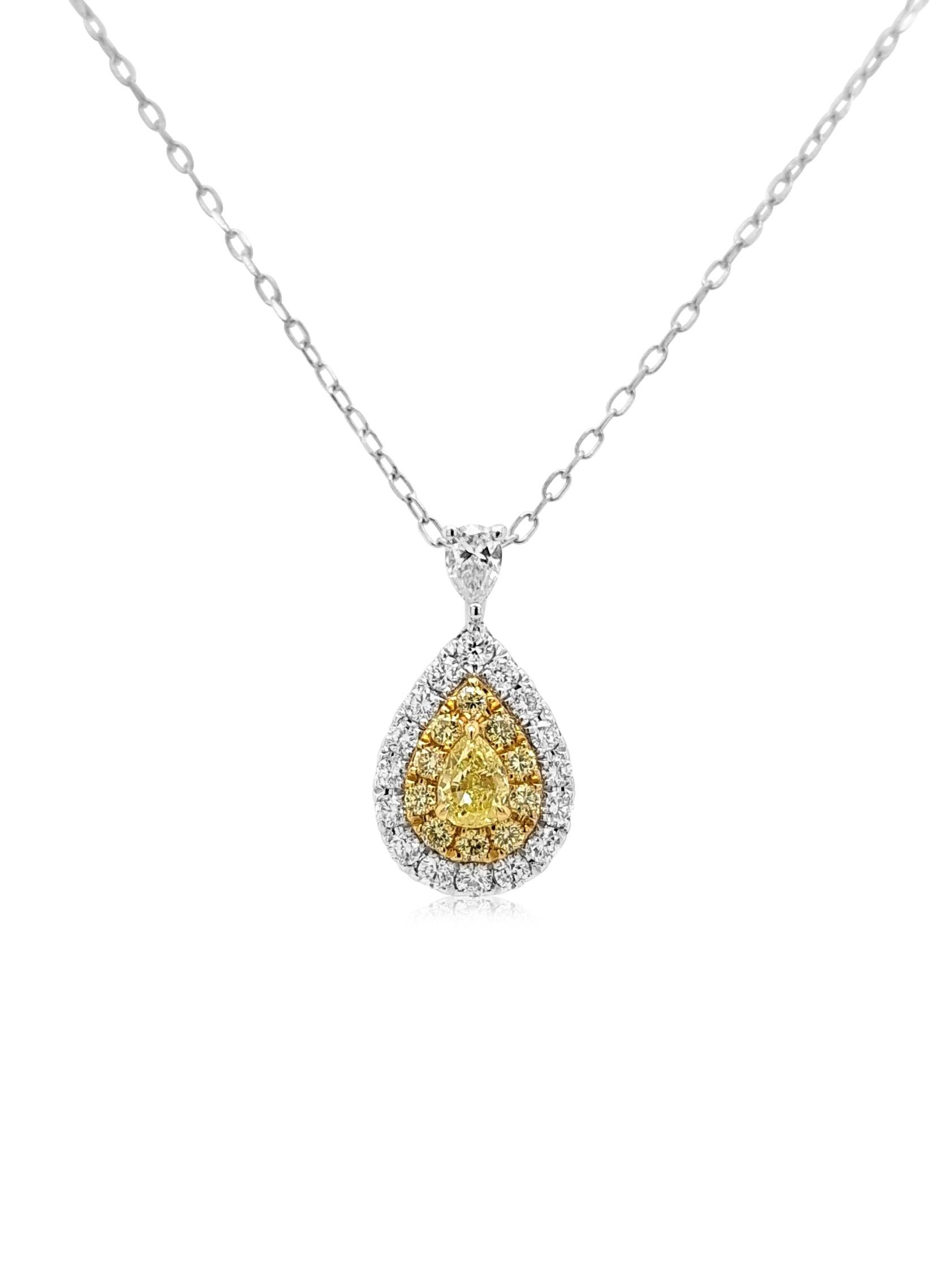  A perfect blend of elegance and contemporary artistry, this piece is crafted to allure charm. Pear Shape Natural Fancy Yellow Diamond at the center with brilliant-cut round Yellow diamonds surrounding it, designed with white diamonds for a rich and