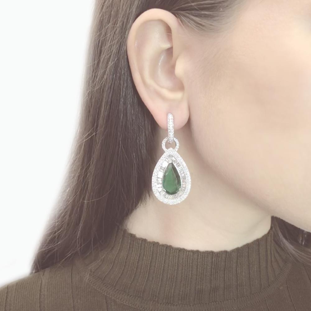 A gorgeous and elegant emeralds and diamond 18 karat gold drop earrings.
Zambian emeralds are pear cut 13.52 carat total.
Accented by round diamonds 7.58 carat total.
Diamonds are white and natural in G-H Color Clarity VS.
18 karat white gold.
Lever