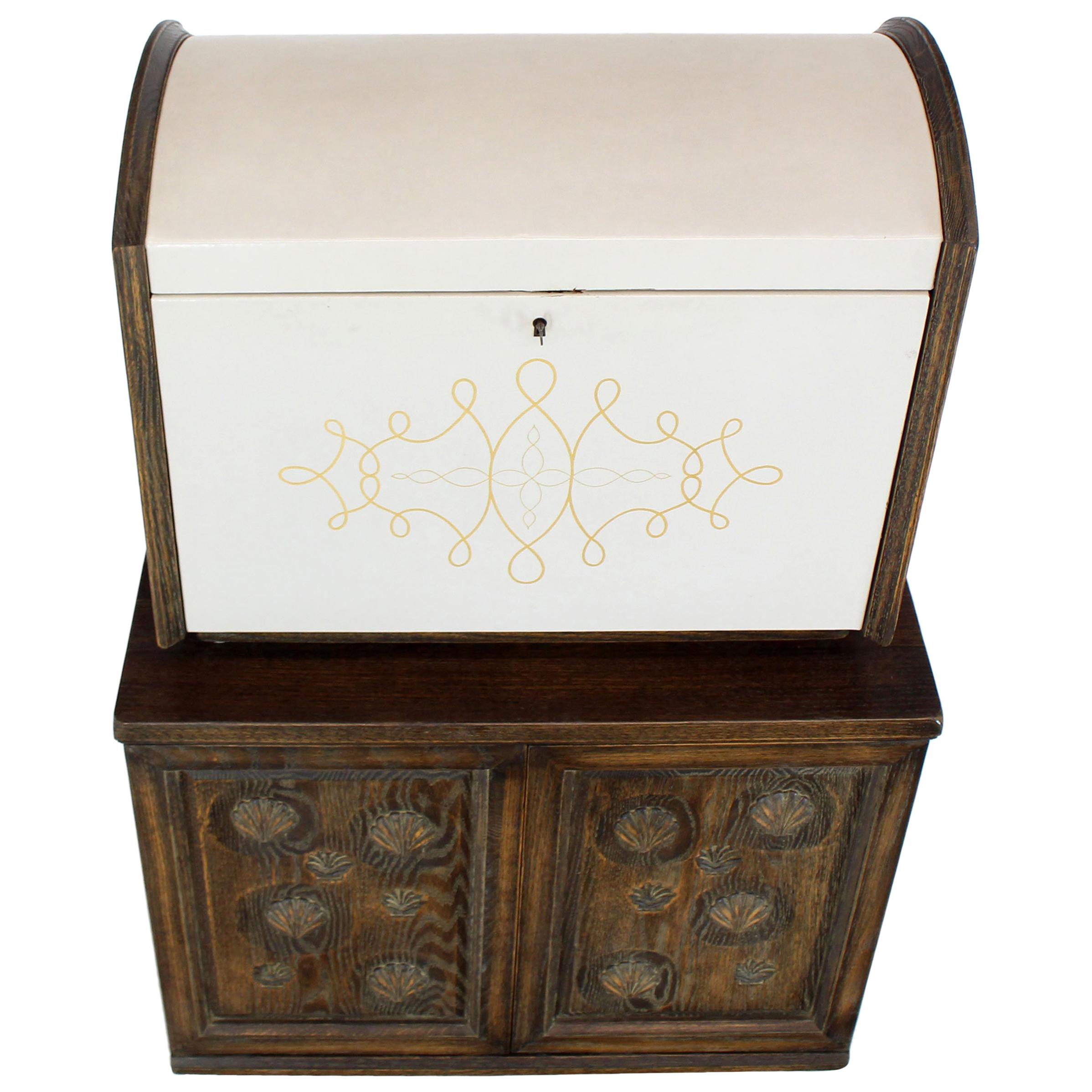 Tooled off white leather wrapped Campaign style transportable trunk shape secretary desk with matching bachelor chest. Two part cabinet. All heavy deeply carved solid oak cerused finish design. Solid brass hardware. Style of James Mont Jean Michel