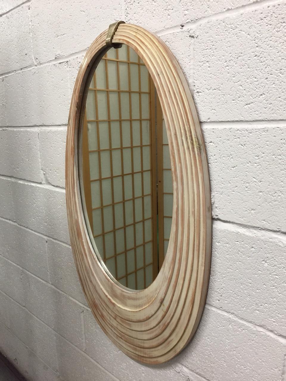 Decorative Cerused wood mirror with a bronze medallion.