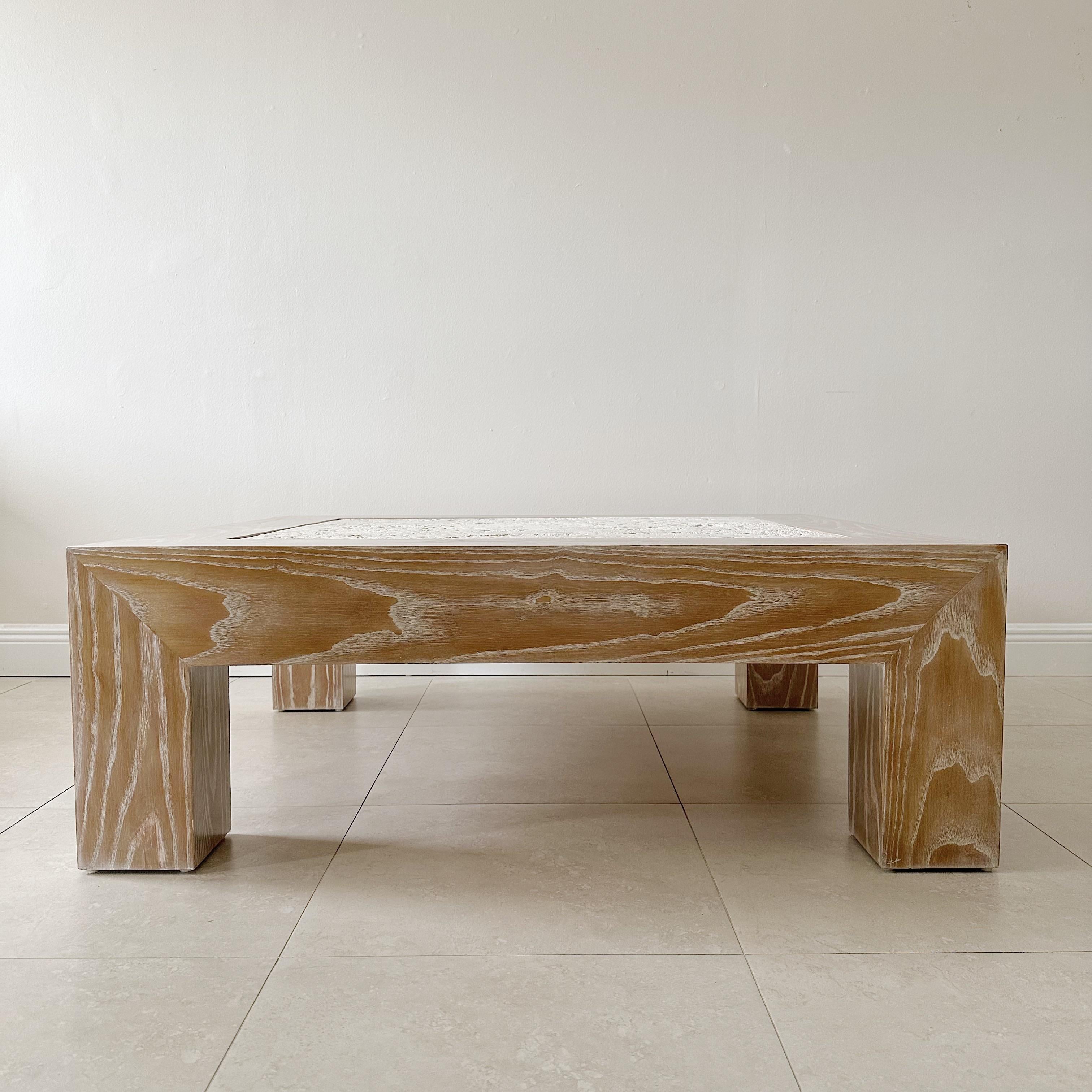 Professionally restored coffee table from the 1970s, featuring an organic 2-inch thick solid coral coquina stone insert set into the cerused oak table base. This unique combination of materials creates a stunning visual effect, with the natural