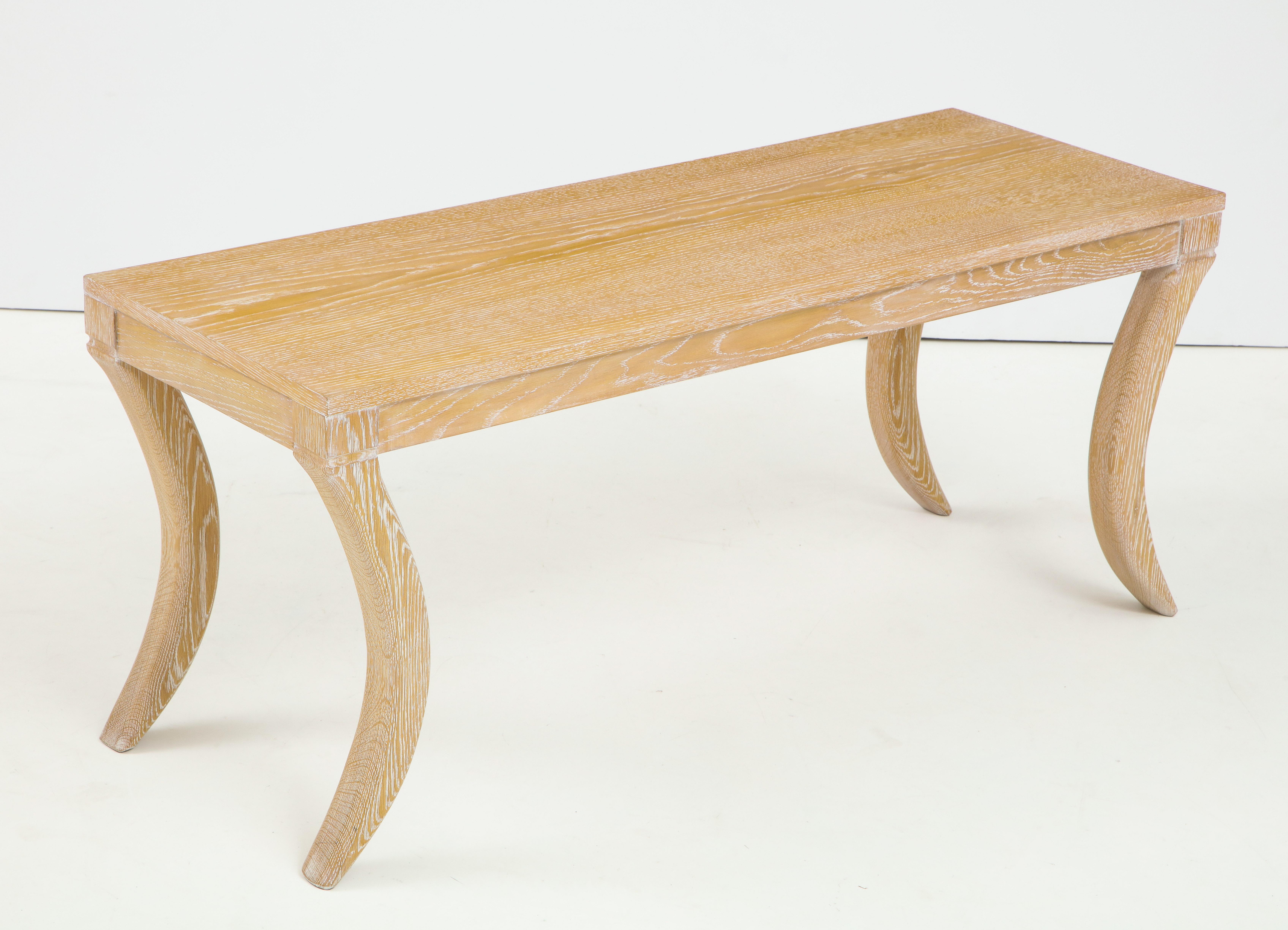 Custom cerused oak bench/cocktail table on sabre legs. Please note that this item is customizable. It can be crafted in a variety of woods and finishes.
Lead Time is 8-10 weeks.  One table is currently in stock.