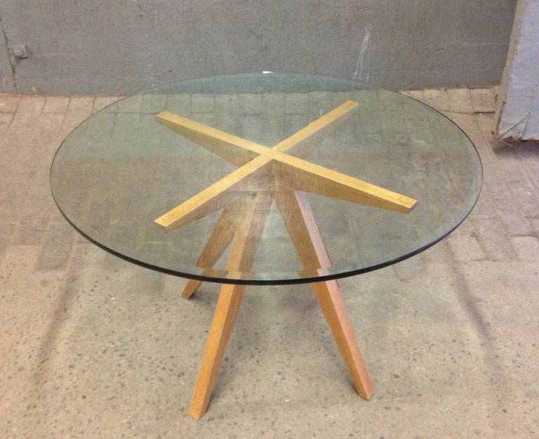 Cerused oak center table. The table has a beveled round glass top.
