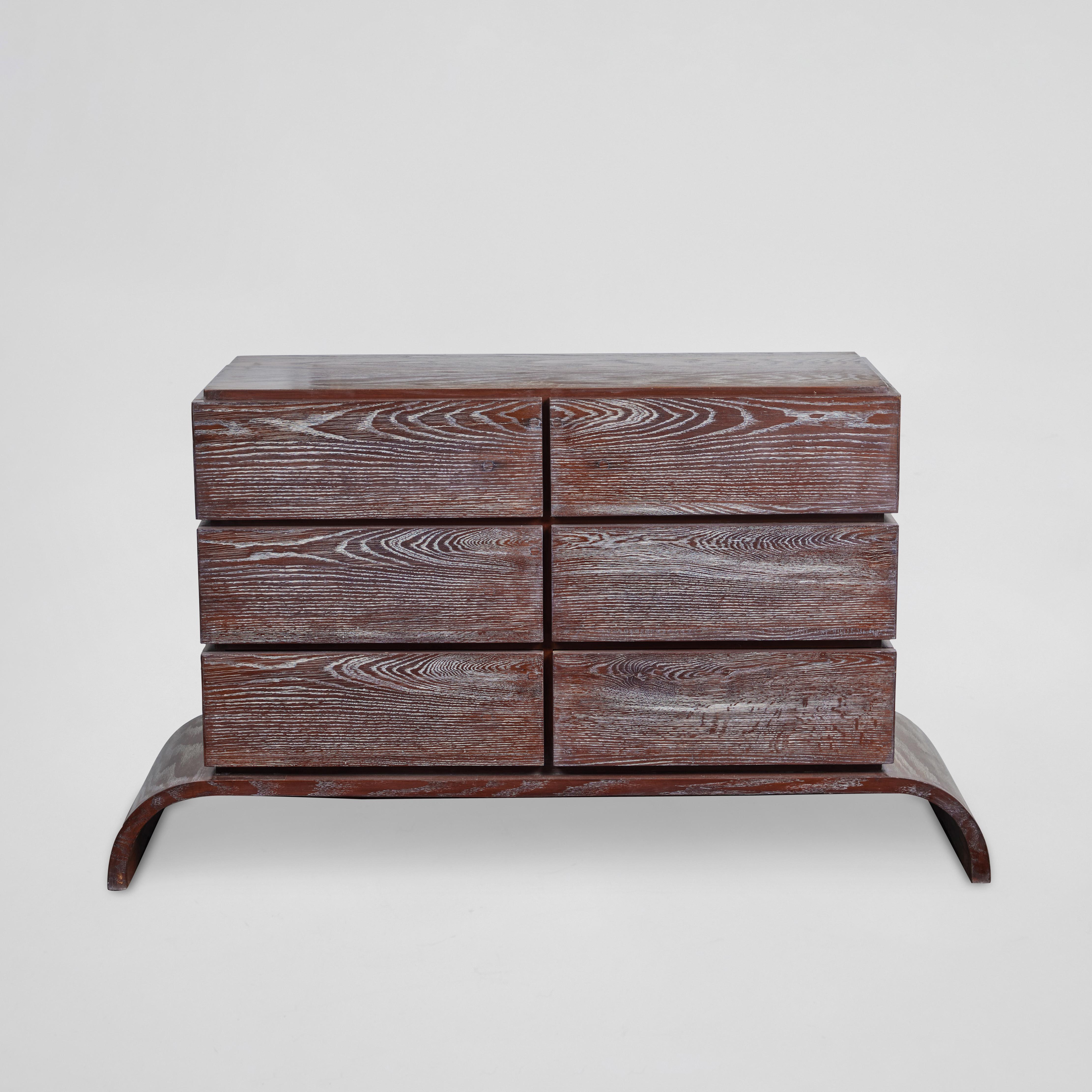 Chic dresser comprised of six drawers atop a curved base in cerused oak in the style of Paul Frankl.