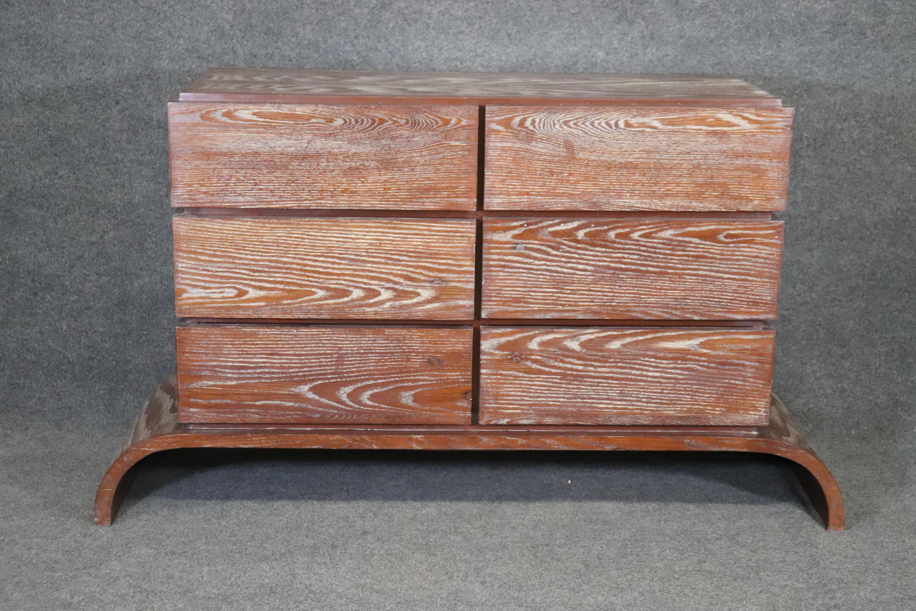 This is a gorgeous cerused oak dresser or commode that is designed in the style of Gio Ponti. The commode is in good vintage condition and has minor signs of age and wear. The wood quality is absolutely beautiful and the piece is solid and heavy.