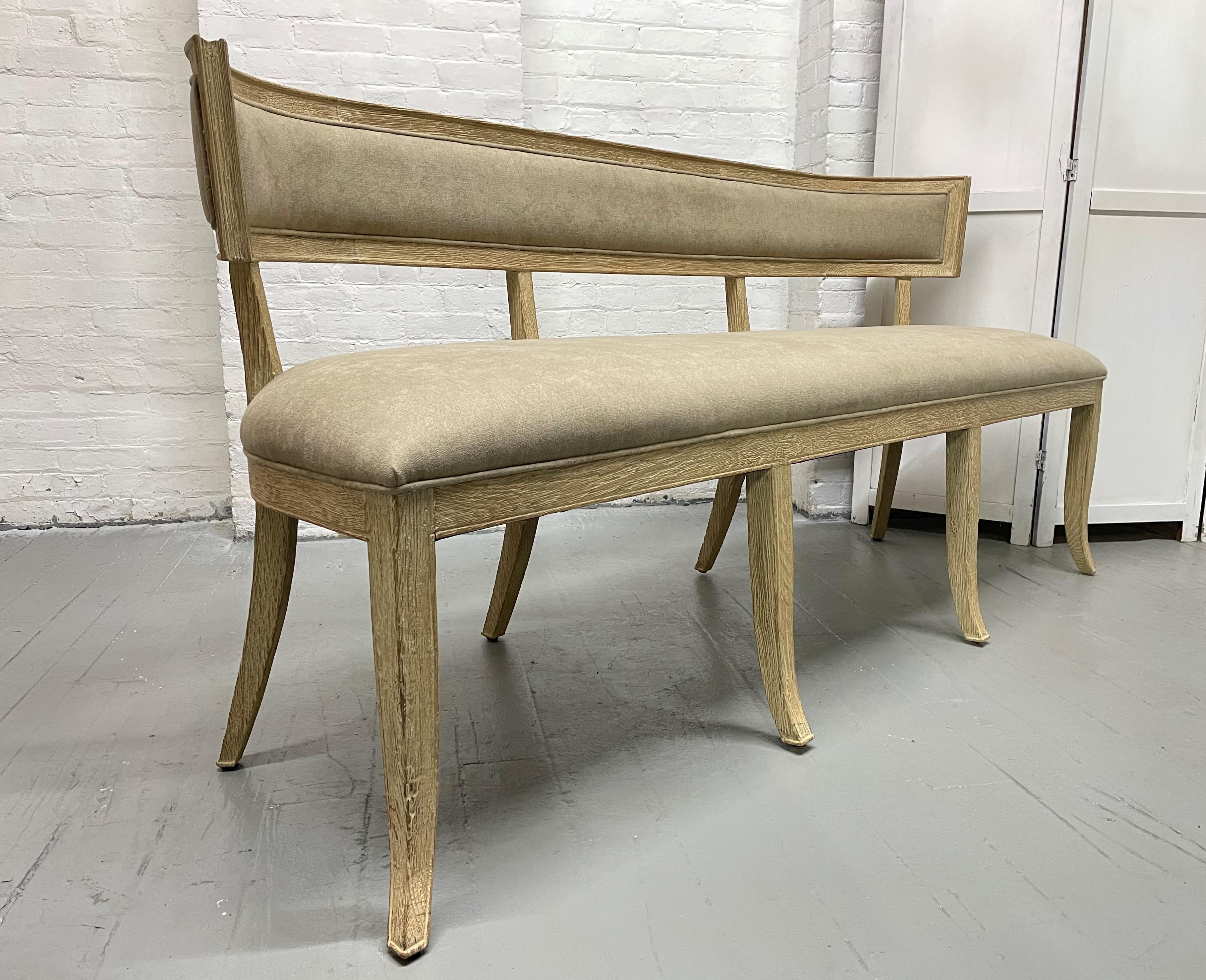 Pair of Cerused oak neoclassical style benches or loveseats. The benches have newly covered fabric seats with each having 8 legs.