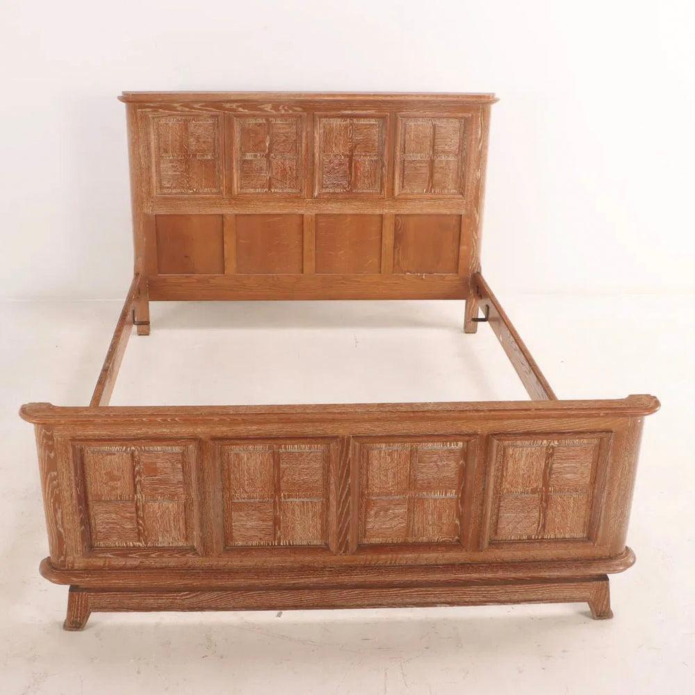 Immerse yourself in the timeless sophistication of this 1940s French cerused oak full-size bed, a rare piece that beautifully captures the elegance of its era. Expertly crafted with a refined paneled design, it highlights both strength and artistry,