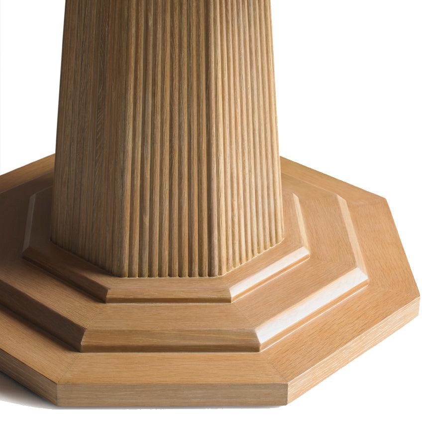 This large-scale 60” diameter dining table has a top and base finished in cerused oak. The pedestal base is reeded and octagonal in shape. This piece is made for people to live around - it anchors a room and will comfortably seat a houseful of