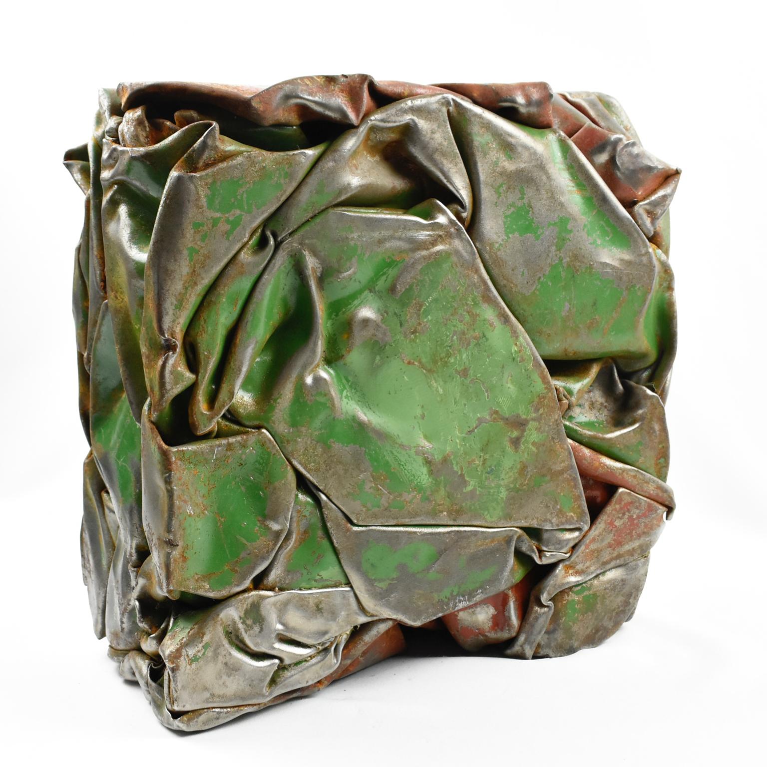 Stunning French abstract sculpture, featuring a compression of industrial metal elements. Eye-catching design with original paint in green and red color with raw metal detailing. Each face offers a versatile view of the artist's work. French artist
