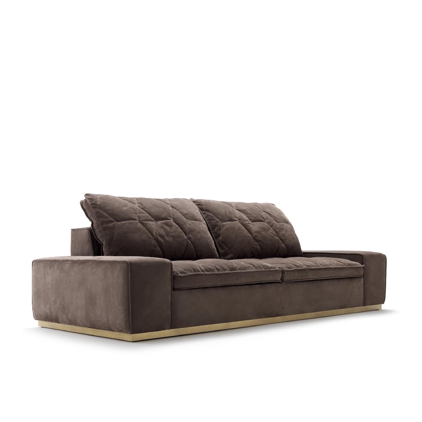 This exquisite sofa will make a statement in a contemporary interior, thanks to its bold silhouette, elegant finishes, and imposing size. Ample enough to seat the people, this piece rests on a plinth base in metal with a satin brass finish. The