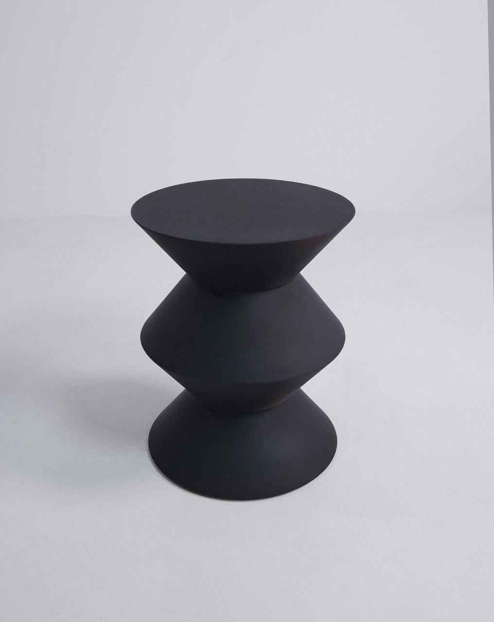 Sculptural stool / side table designed by Rodolfo Dordoni and produced by Minotti. Refinished in matt black.