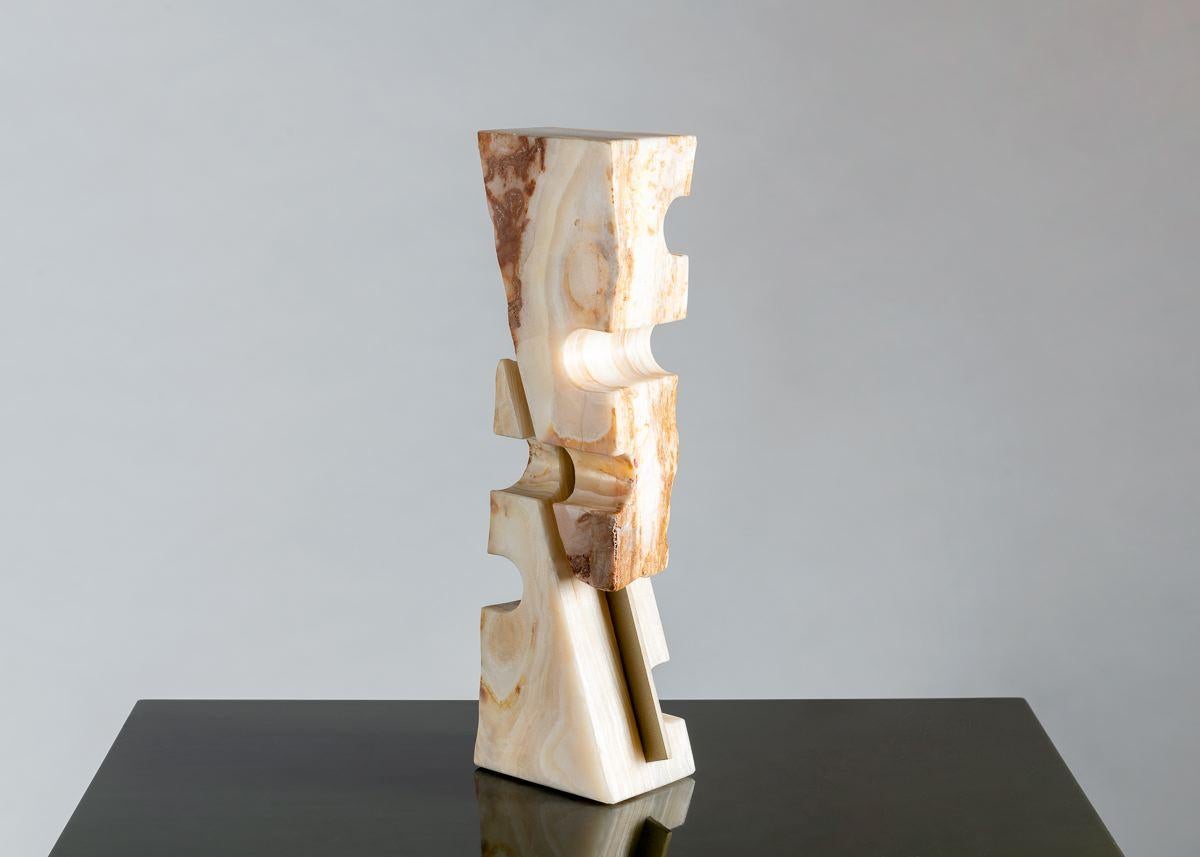 With this extraordinary piece, Cesare Arduini has imposed geometric coherence on the natural but chaotic beauty of onyx, in this case using brass, the very opposite of his chosen medium, to both divide his two cuts of stone, and unite them into a
