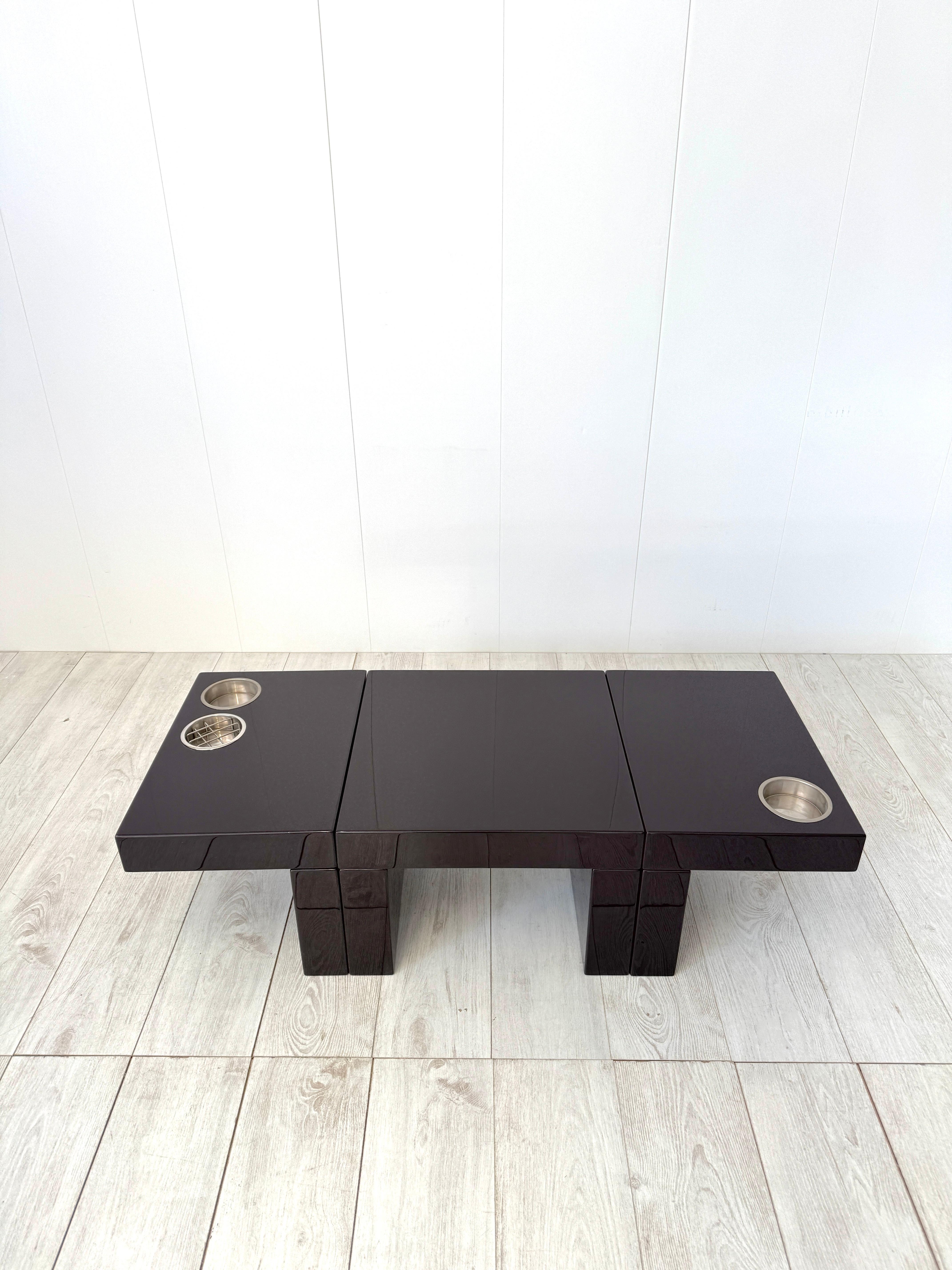 Elegant set of 3 lacquered wood sectional side tables  dark brown color and chromed metal bottle/glass and ashtray compartments.
Production Cesare Augusto Nava, 1970s
The composition of coffee tables can be adapted to one's needs, creating geometric