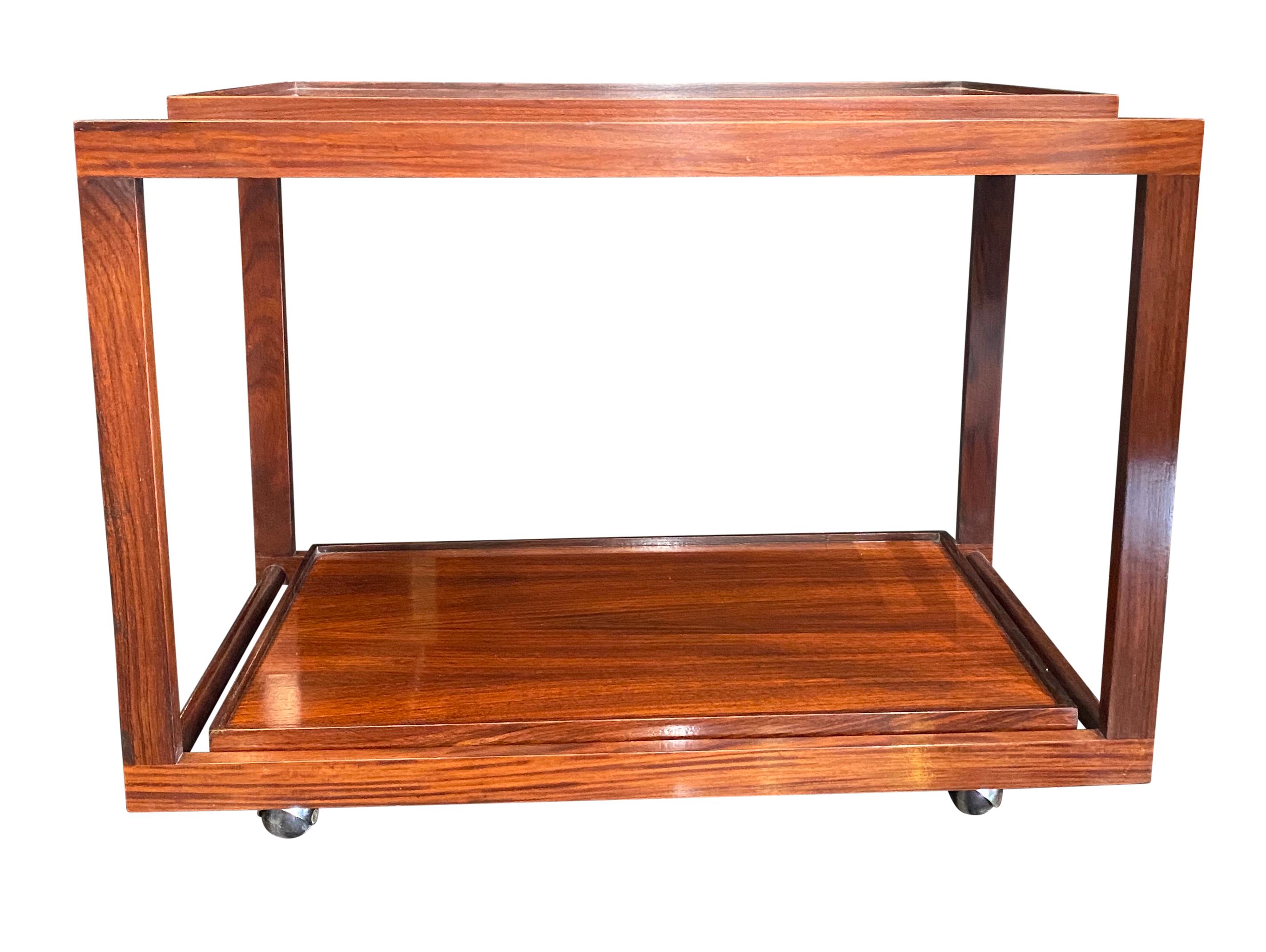 A fabulous two tiered mahogany bar cart with detachable trays designed by Cesare Lacca for Cassina 
(Marked with original label).



 