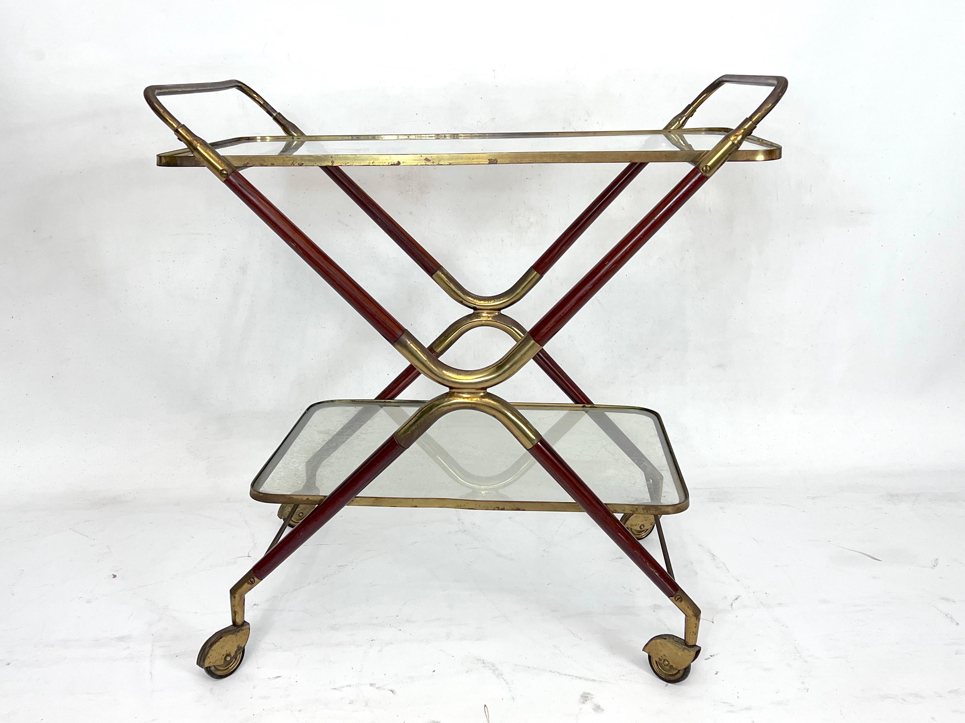 Good vintage condition with evident trace of age and use for this bar cart designed by Cesare Lacca and produced in Italy during the 50s. Made from brass, wood and glass. Brass and wood with original patina.
   