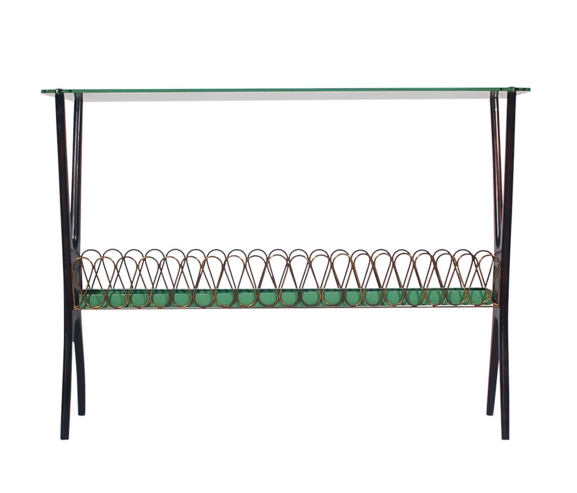 A shallow depth Italian console or hall table designed by Cesare Lacca and made in Italy, circa 1950s. It features a slim solid walnut frame with floating glass top and lower planter area.