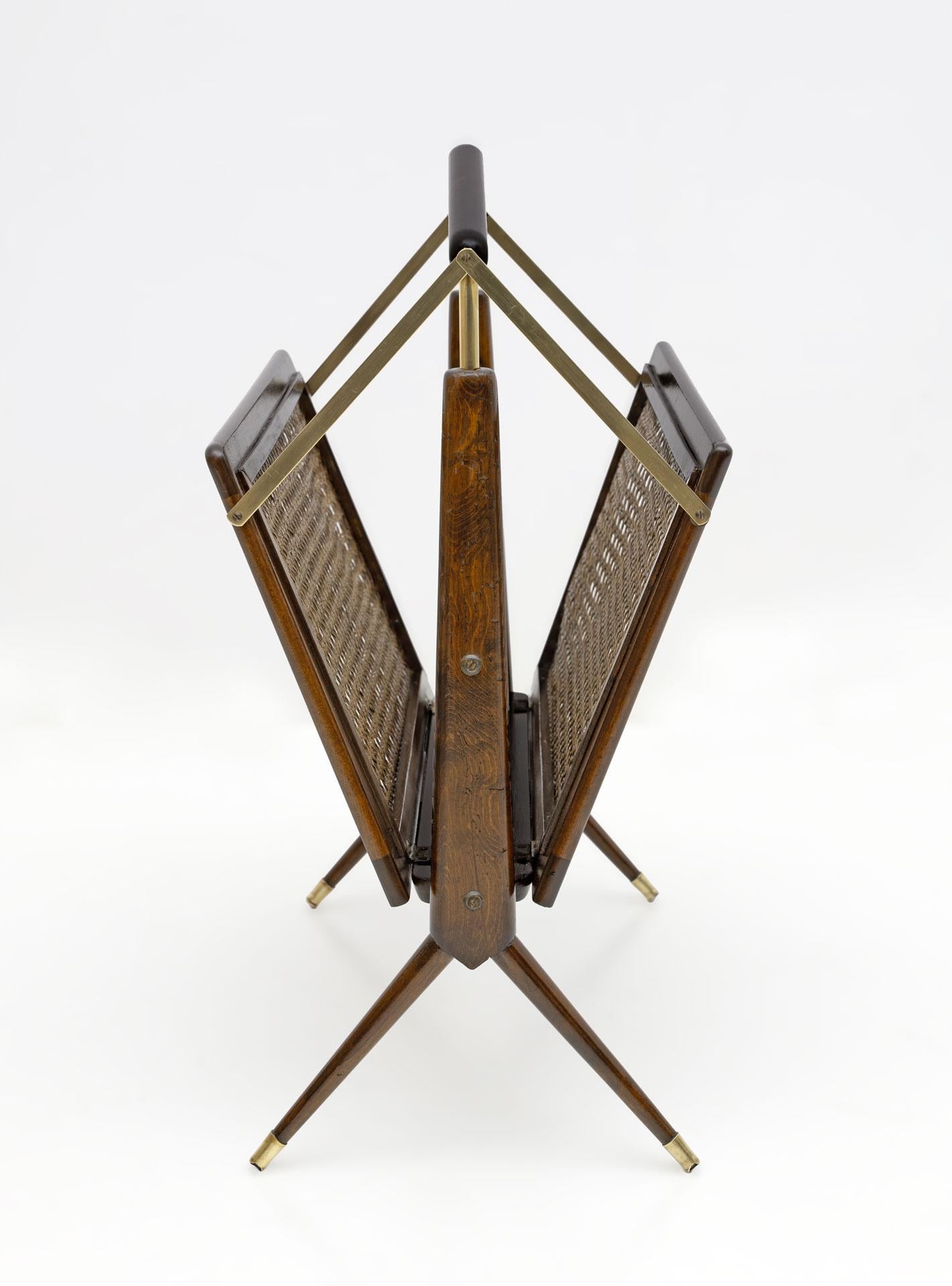 Italian, mid-century modern, walnut, wicker and brass, Cesare Lacca magazine rack folds away from handle for mobility, ingenious design.
Restored and polished with shellac.