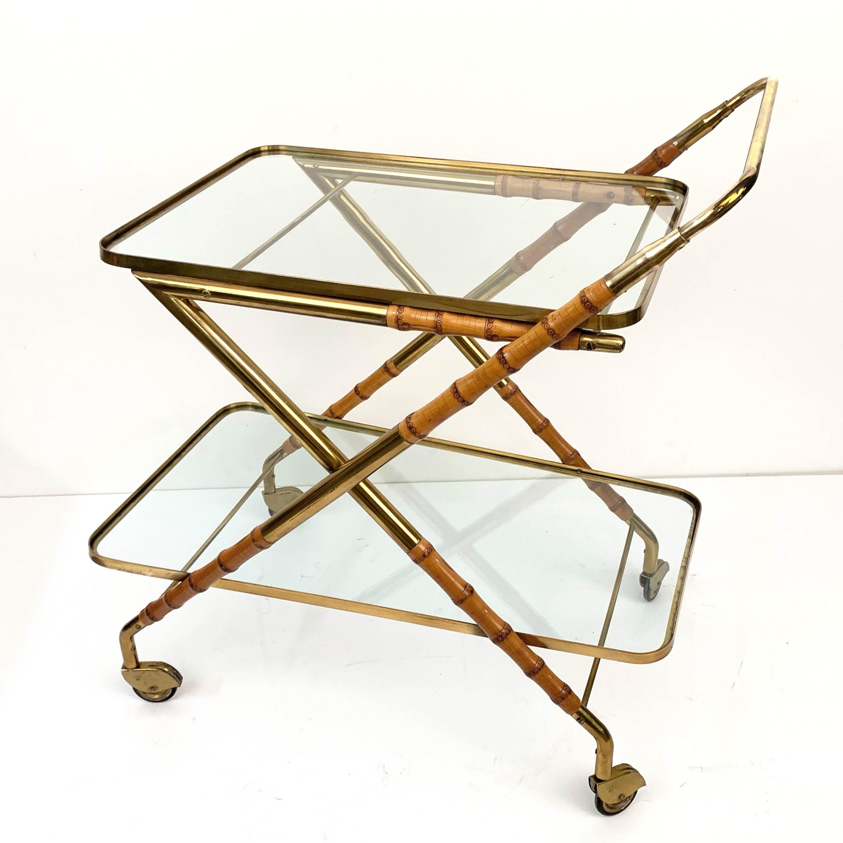 Amazing midcentury bamboo and brass bar cart with glass shelves. This rare piece was designed in Italy during 1950s and it is attributed to Cesare Lacca.

This item is unique for the mix of materials in its structure, that is brass and bamboo. In