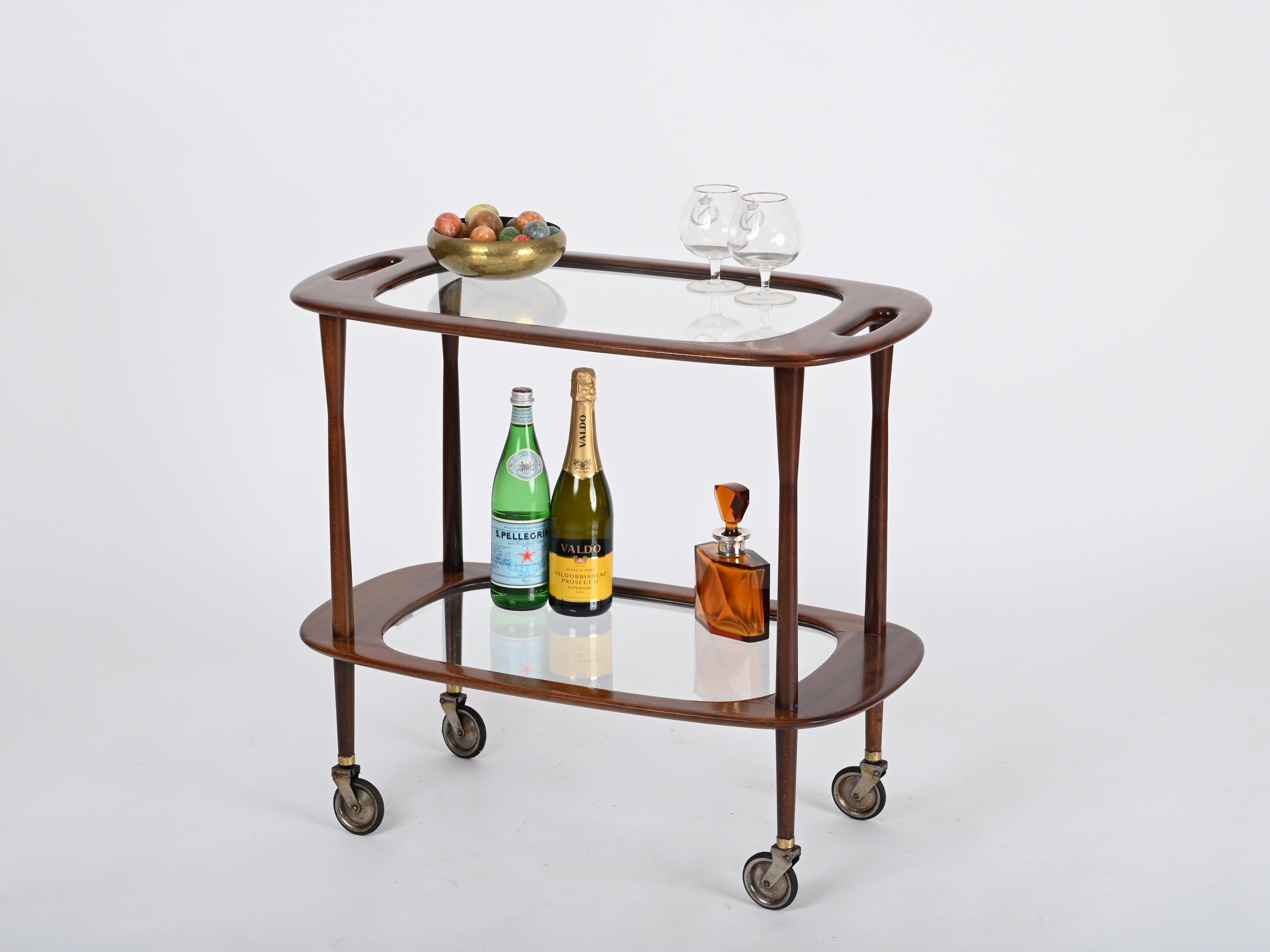 Spectacular midcentury bar cart in a gorgeous mahogany wood.  Designed by Cesare Lacca and produced by Cassina in Italy during the 1950s.

Fully original and in amazing conditions.  This two tier serving bar cart is made in solid mahogany of