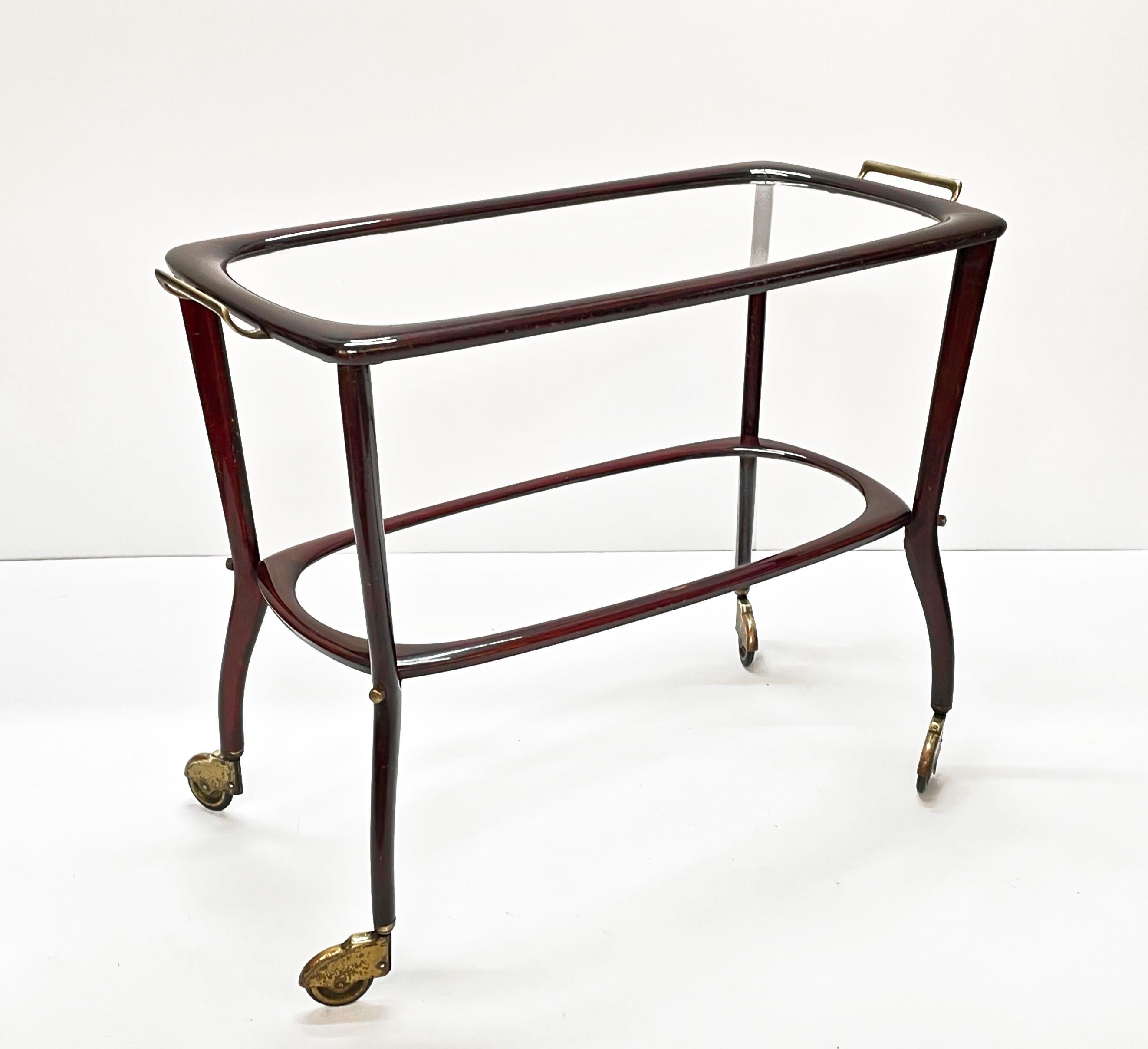 Amazing midcentury wood and glass trolley bar cart. This fantastic item was produced in Italy during the 1950s by Cesare Lacca.

The smooth lines are just fantastic and the mix with the crystal glass shelves make this item light and delicate. The