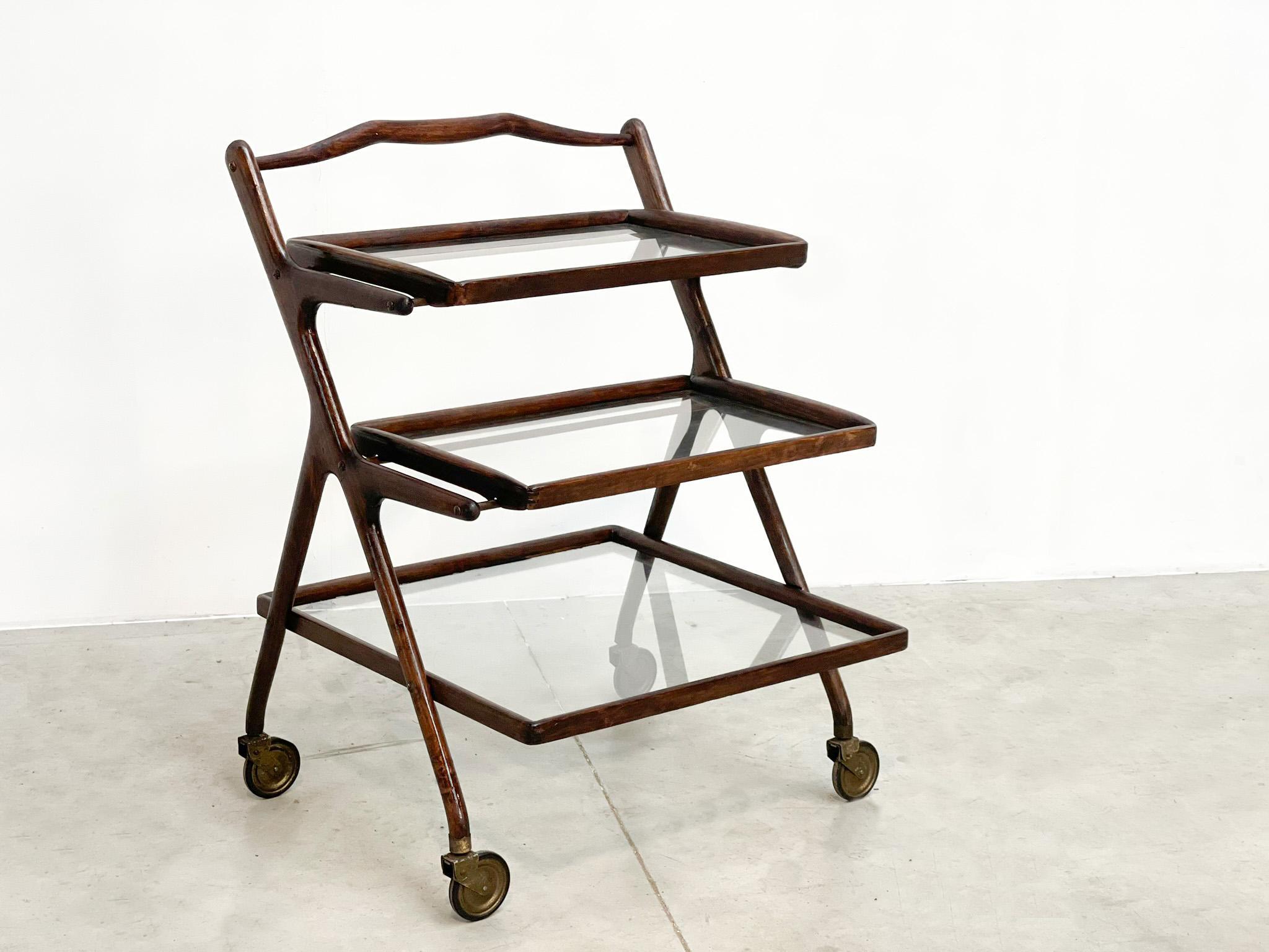 very nice and versitile bar trolley by the famous italian designer Casare Lacca.
He designed this in the 50s for Cassina. It has 3 trays, the 2 upper ones are removable. 
It has a ebonized walnut frame with brass accents. 

 

Perfect to put