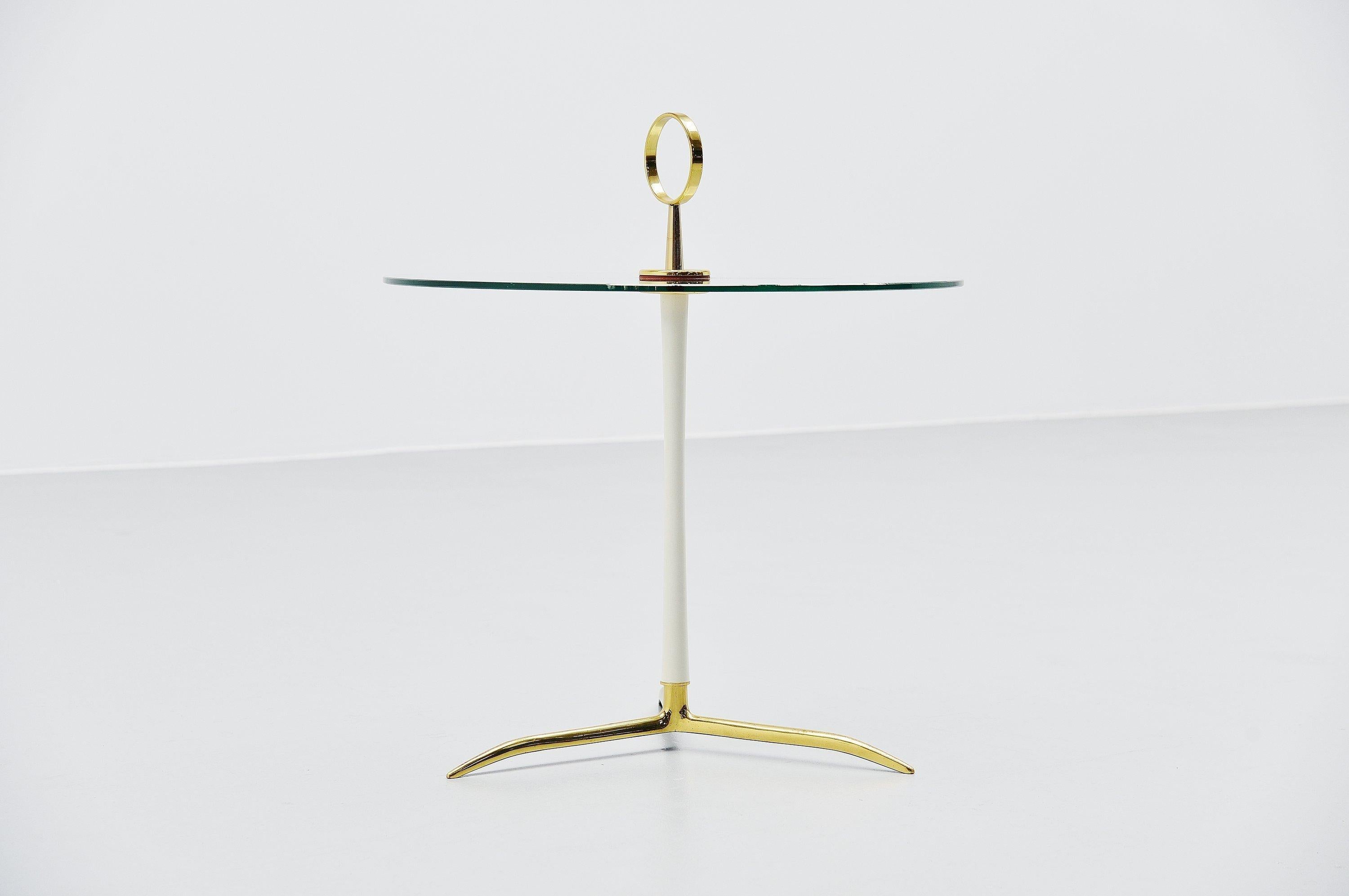 Sophisticated side table designed and manufactured by Cesare Lacca, Italy 1950. This table has a solid brass tripod base and white bar. It has a round brass handle to easily grab it and move it while vacuum cleaning for example, or use it elsewhere.