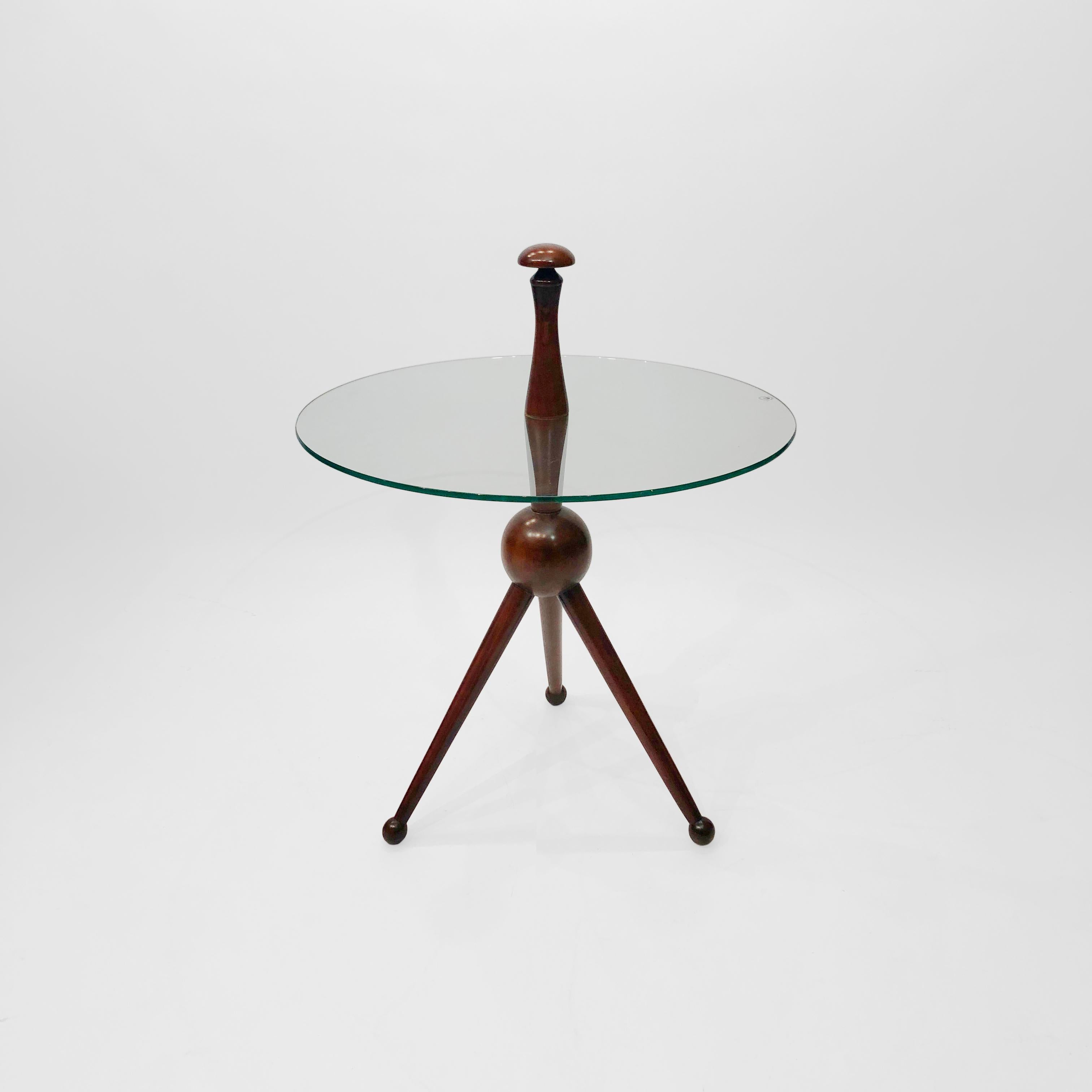 A Cesare Lacca tripod side table, originating from the late 1950s and a stunning example of Italian mid-century design. Three wooden ball end feet join on to a bigger centre ball, from which protrudes a central supporting rod. This then separates,