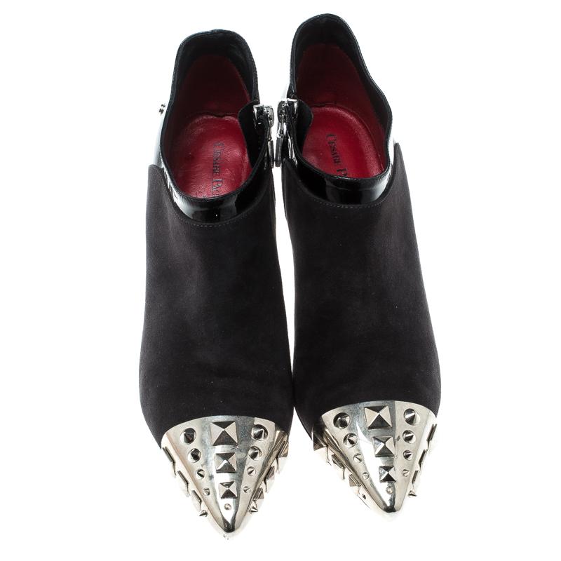 These ankle boots from Cesare Paciotti are all you need to make a statement and win all the admiration! The black boots are crafted from suede and leather and feature silver-tone studded cap toes. They flaunt side zippers and come equipped with