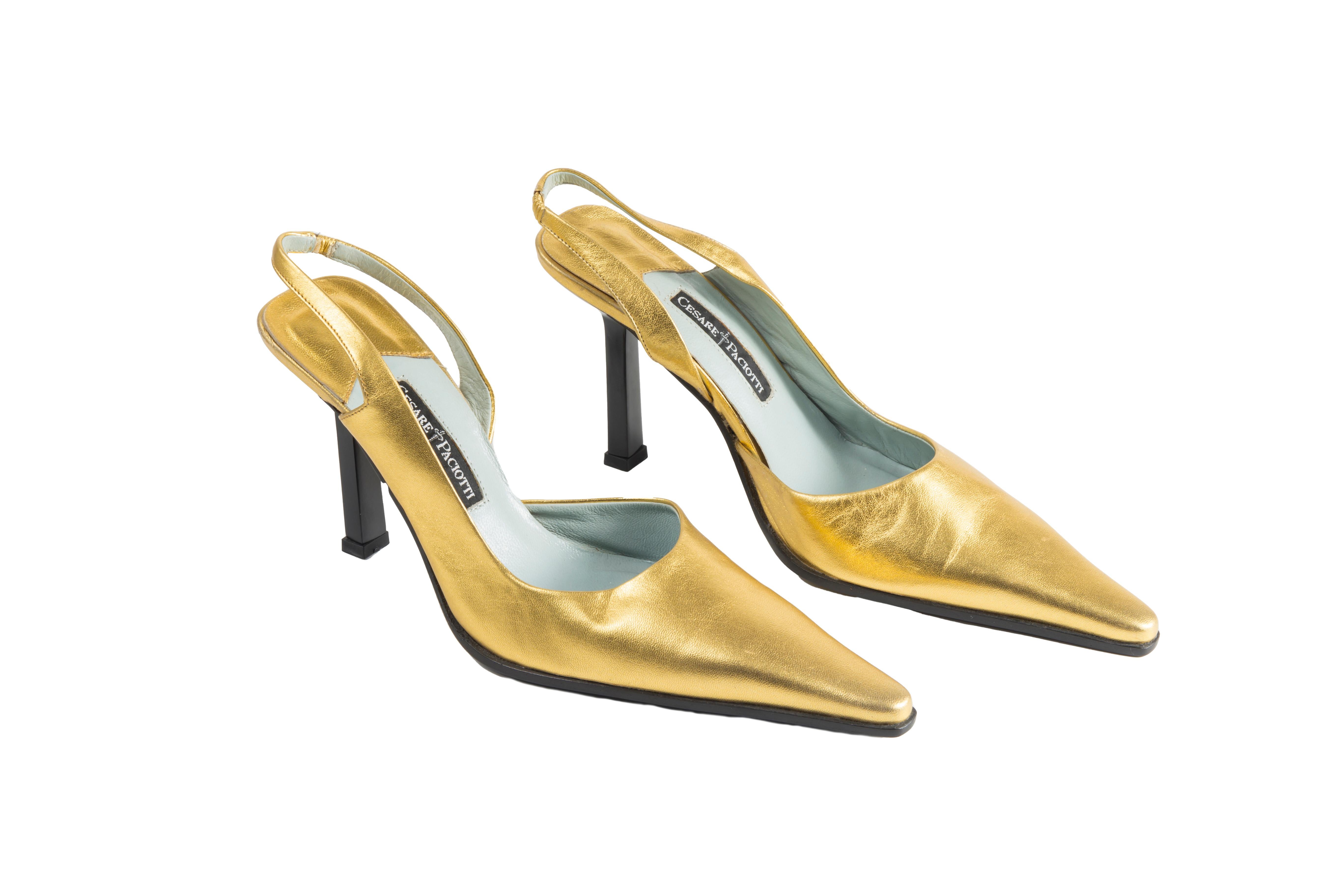- Cesare Paciotti golden slingbacks
- Sold by Gold Palms Vintage
- Early 2000s
- Gold metallic leather pumps
- Pointed toe
- Black square heel