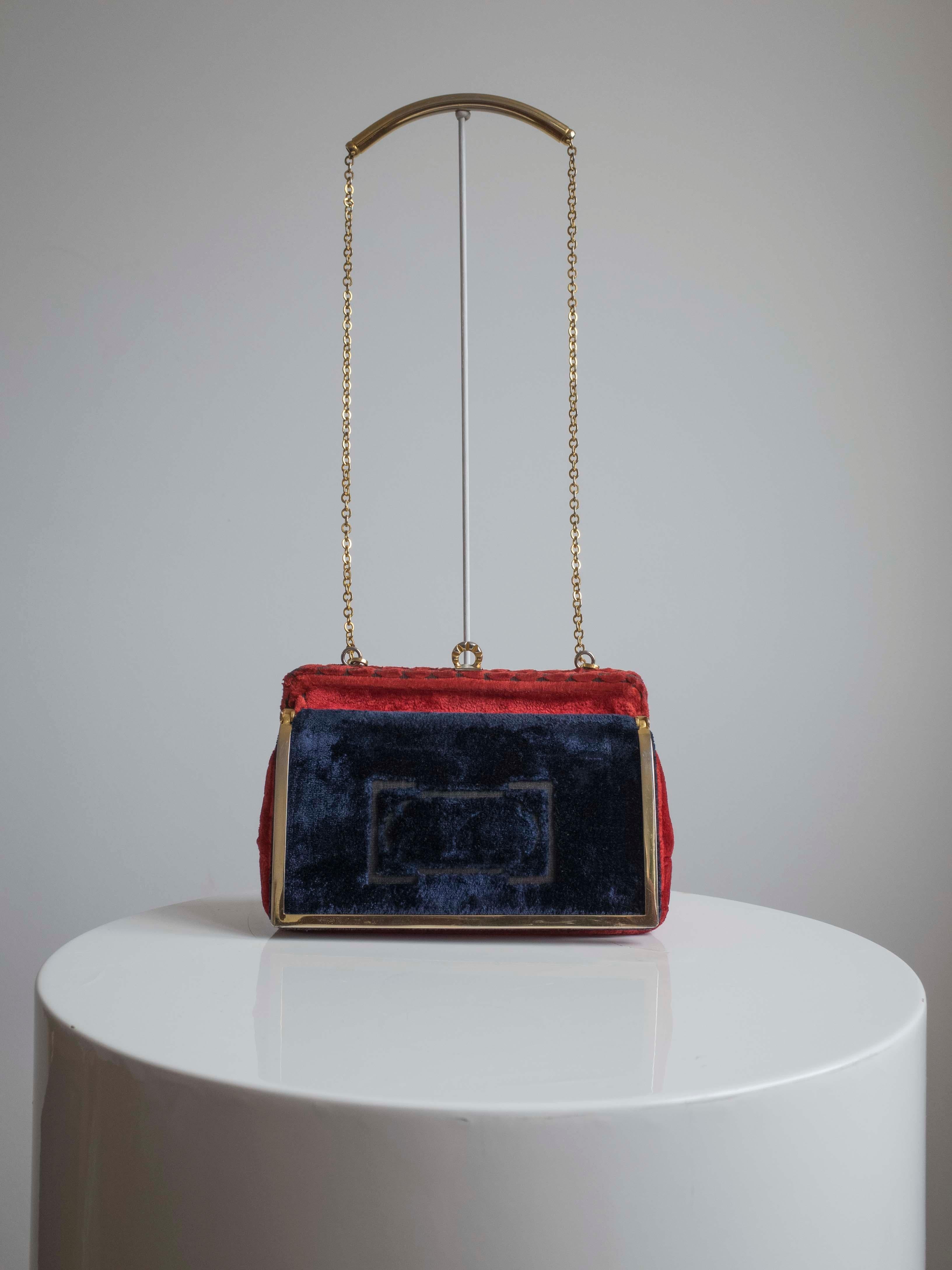 Vintage Cesare Piccini Purse

Vintage handbag by Cesare Piccini rich red velvet with contrasting navy pocket. 
Embossed scroll design in the velvet. Brass trim, clasp and chain strap,the purse opens to a main leather compartment with two smaller