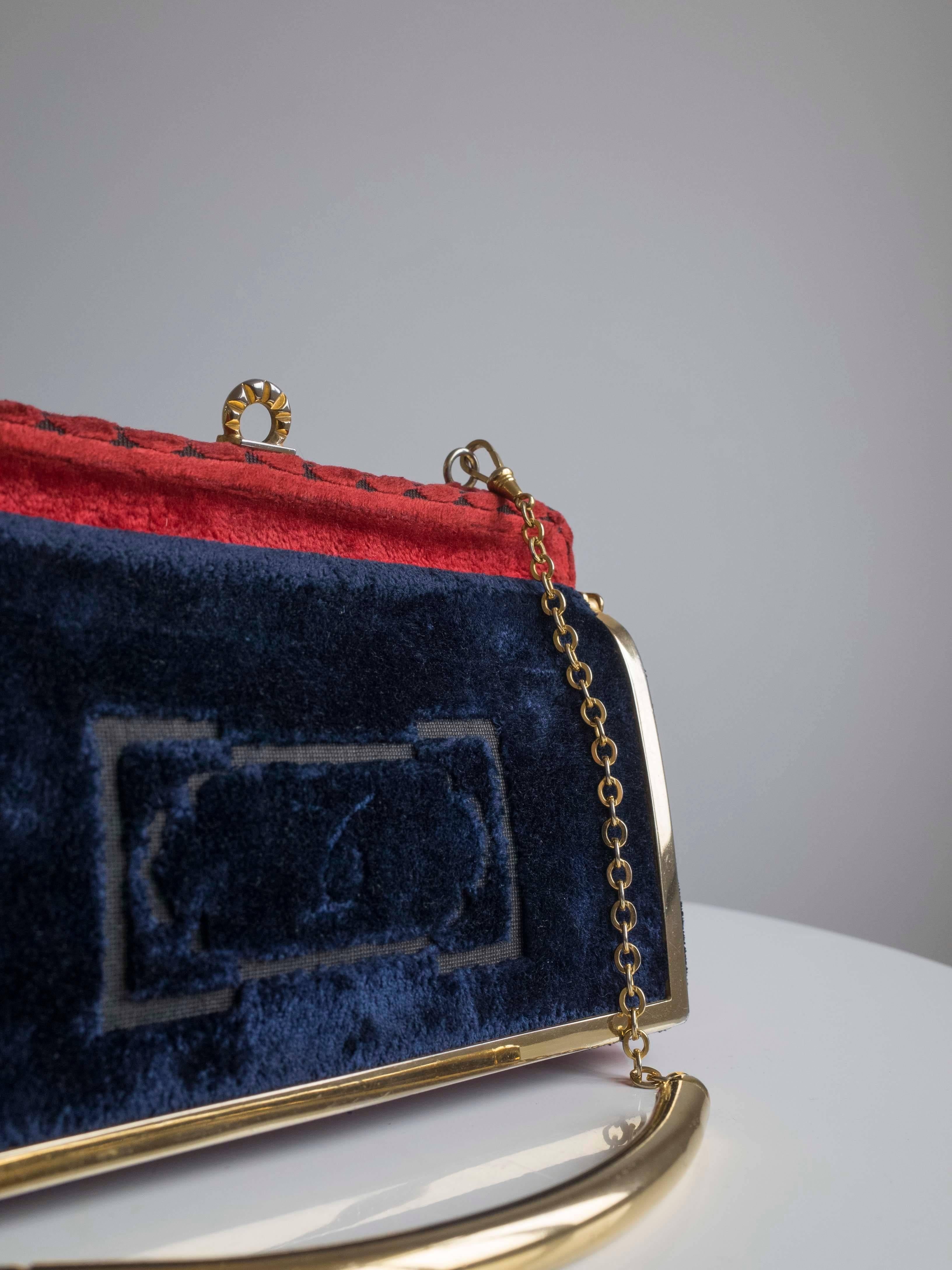 Vintage Cesare Piccini Purse

Vintage handbag by Cesare Piccini rich red velvet with contrasting navy pocket. 
Embossed scroll design in the velvet. Brass trim, clasp and chain strap,the purse opens to a main leather compartment with two smaller