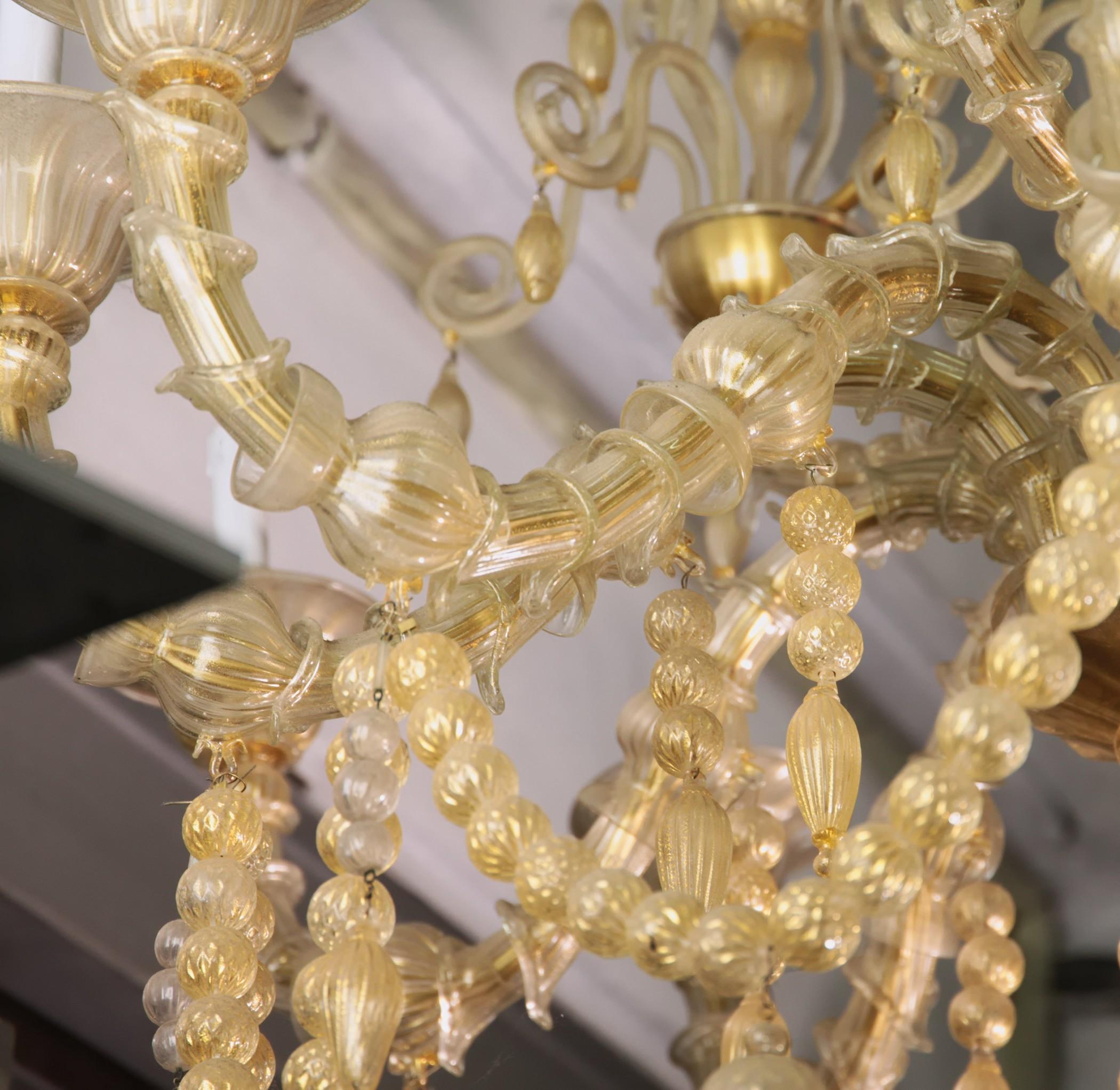 Grand Ca Rezzonico chandelier. All made in clear glass with 24-karat gold leaf embedded into glass.
The use of gold leaf highlights and bring preciousness to the chandelier.
There are two highlights on this chandelier, the first is a row of glass