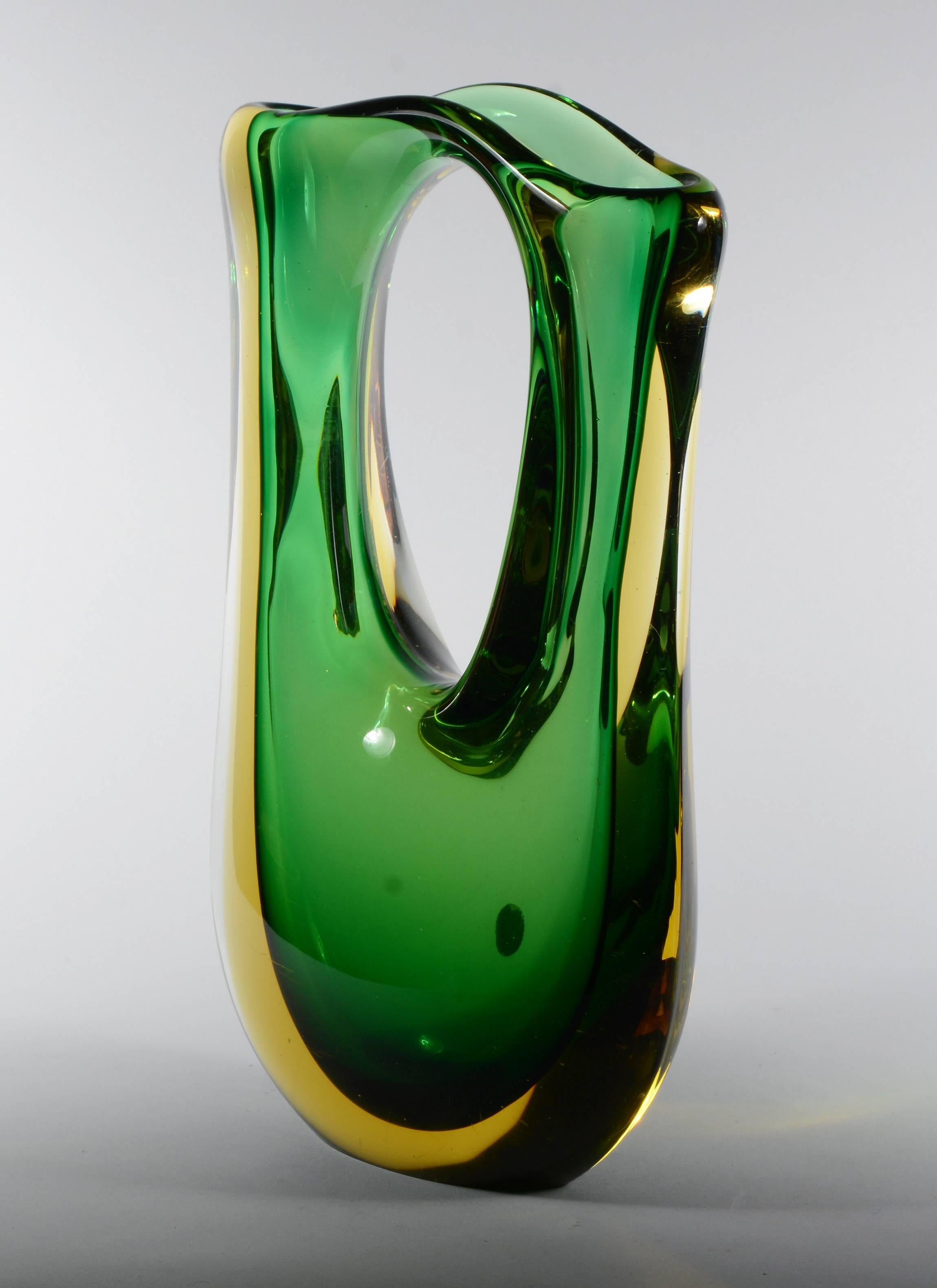 Pierced Sommerso glass vase by Murano artist Cesare Toso. This has a green interior layered with a golden yellow and then clear. The vase retains the Cesare Toso label. There is some slight water stains on the inside and a few scratches on the
