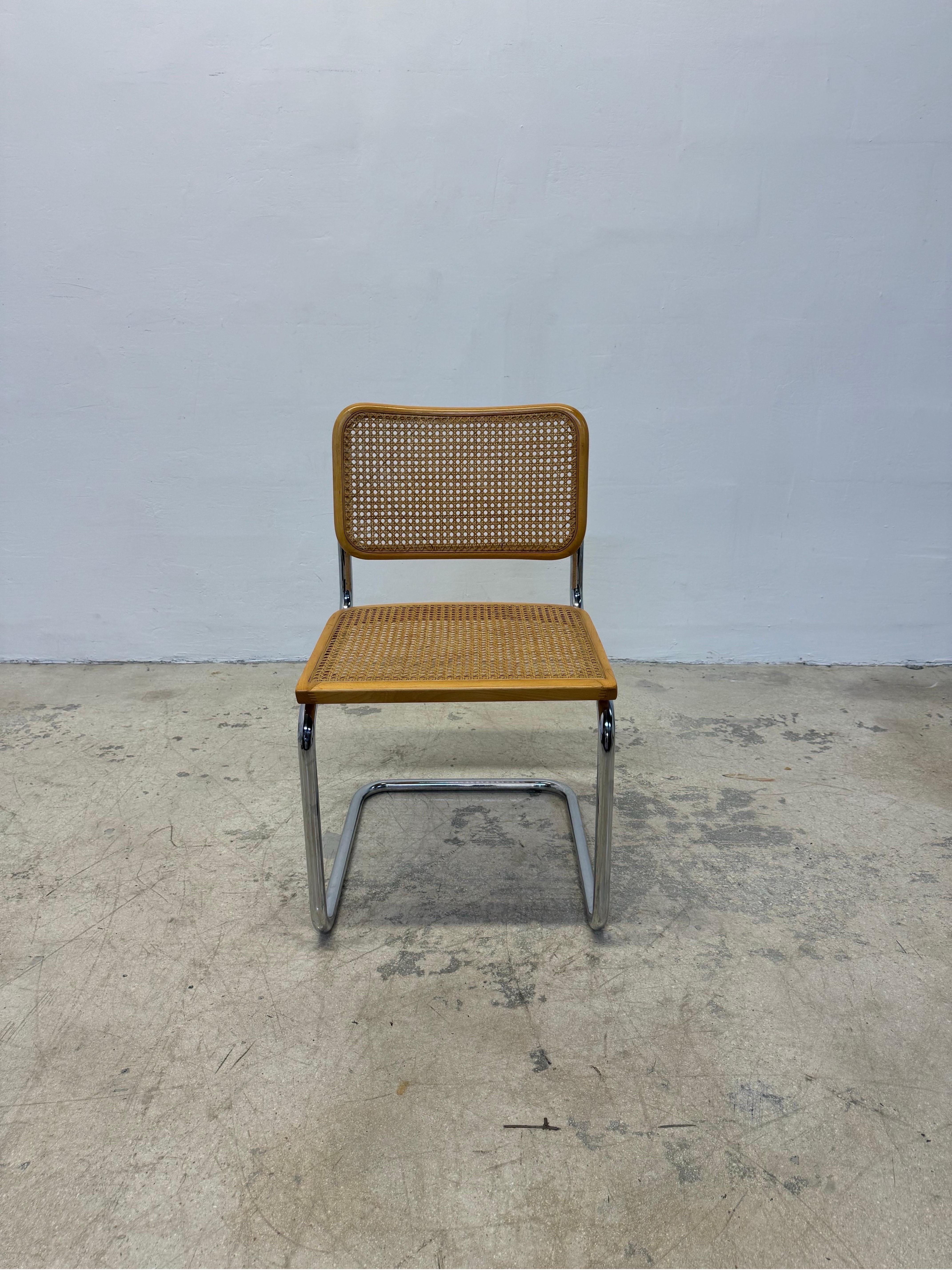 Mid-Century cantilevered Cesca chair with chrome frame and cane webbed wood seat.  This chair was made sometime during the 1970s in Italy and was after the original Marcel Breuer design. Maintains made in Italy label.