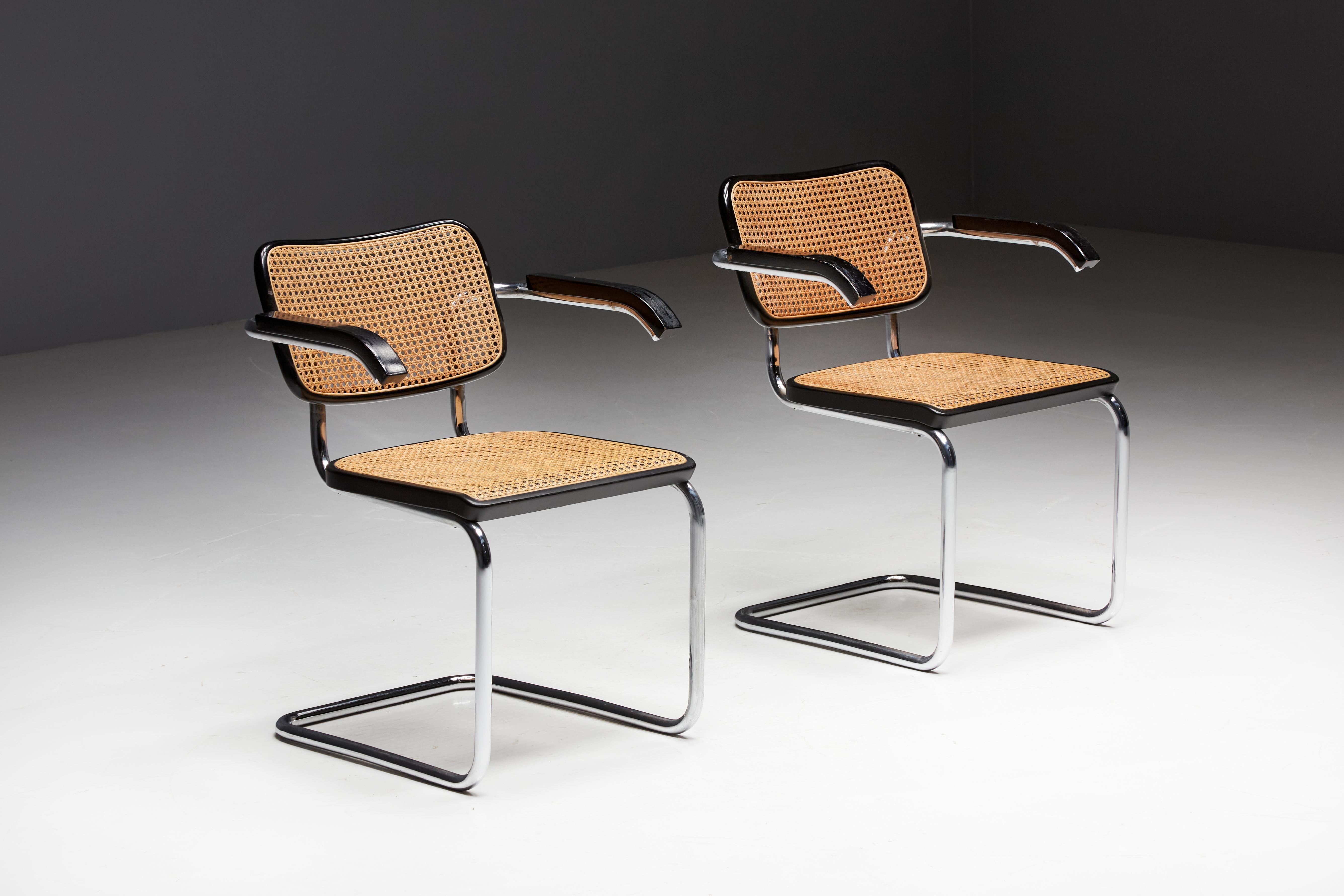 Cesca armchair model S64 by Marcel Breuer for Thonet, crafted in 1992. The frame, meticulously constructed from tubular chrome steel, exudes modern elegance, while the distinctive rattan seating adds a touch of warmth and comfort. The ebonized wood