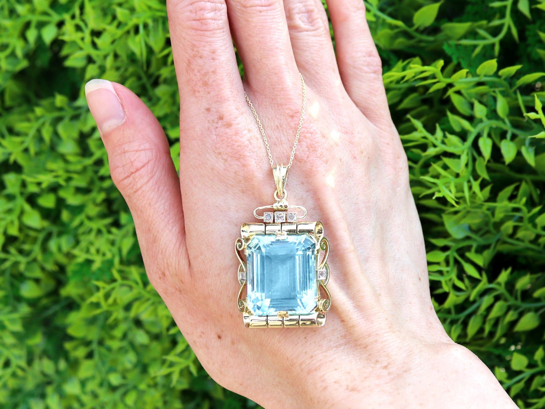 A stunning, fine and impressive vintage 32.20 carat aquamarine, 0.10 carat diamond and 14k yellow gold pendant made by C'est Laudier; part of our diverse vintage jewelry and estate jewelry collections.

This stunning, fine and impressive vintage