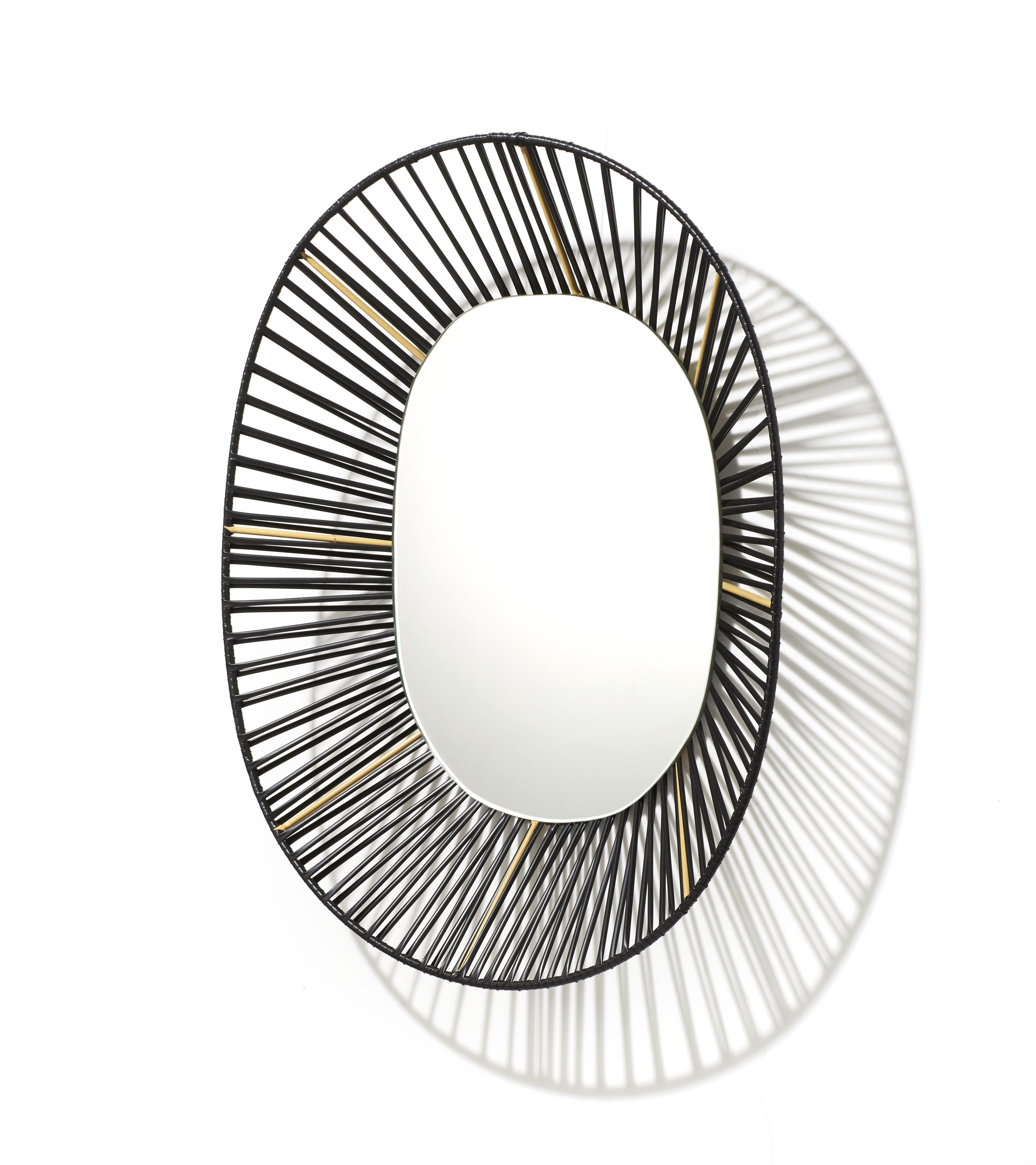 Cesta oval mirror by Pauline Deltour
Materials: Galvanized and powder-coated tubular steel frame. PVC strings.
Technique: Made from recycled plastic. Hand-woven in Colombia. 
Dimensions: W 47.5 x H 54.3 cm 
Available in colors: oliv green/