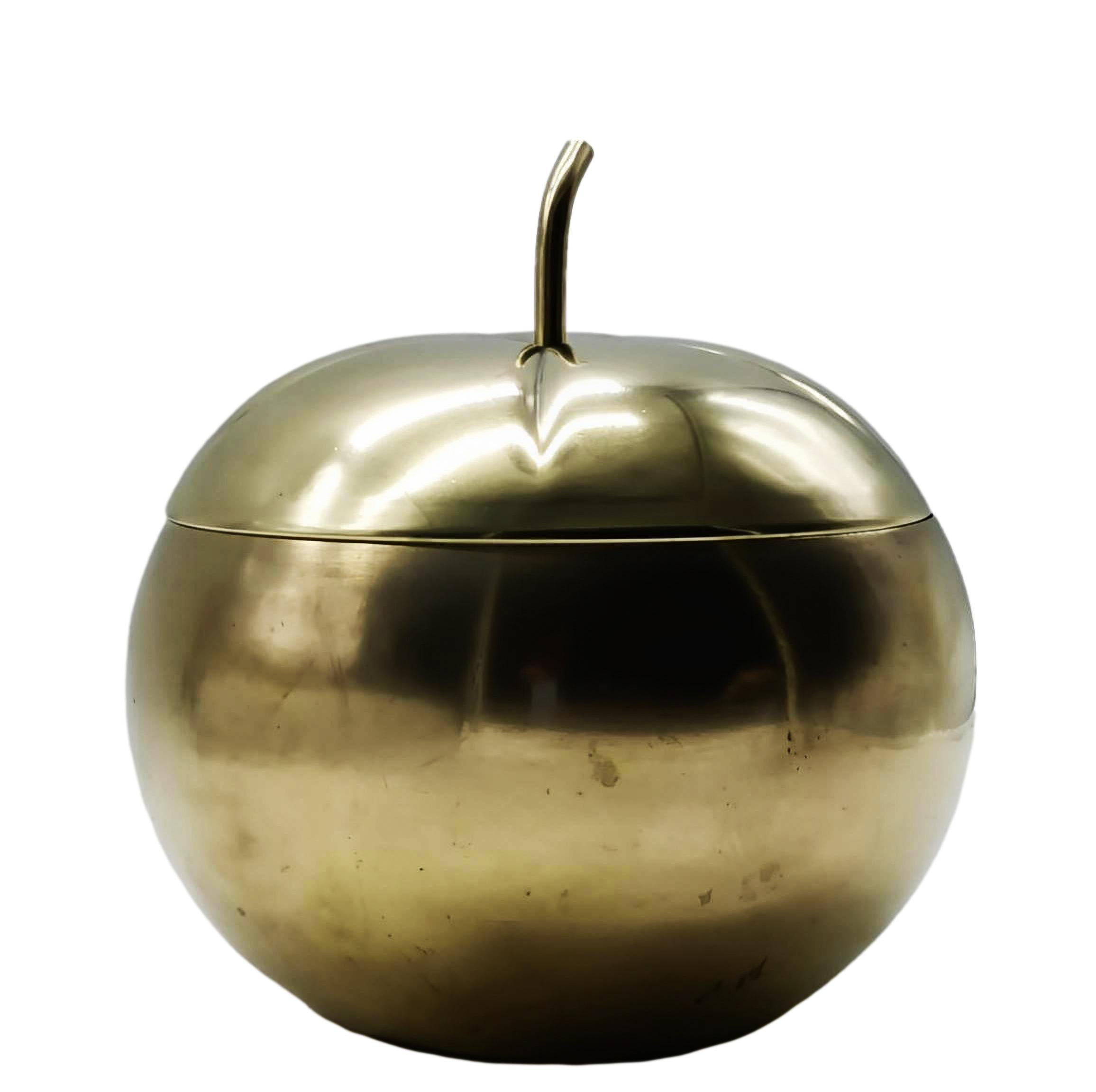 This ice bucket from the 1970s is a unique and elegant piece made of brass, a popular material in that  period. Brass was preferred for its warm, golden hue and ability to patina gracefully over time.  The ice bucket has the round, bulbous shape of
