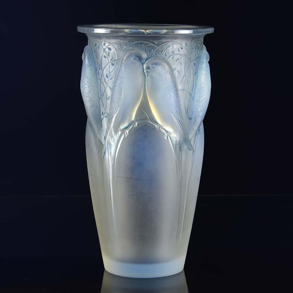 A beautiful early 20th century French Art Deco opalescent glass vase entitled 'Ceylan' by Rene Lalique, with decorative raised figures of birds amongst branches heightened with noticeable original blue staining. The attractive design, quality and