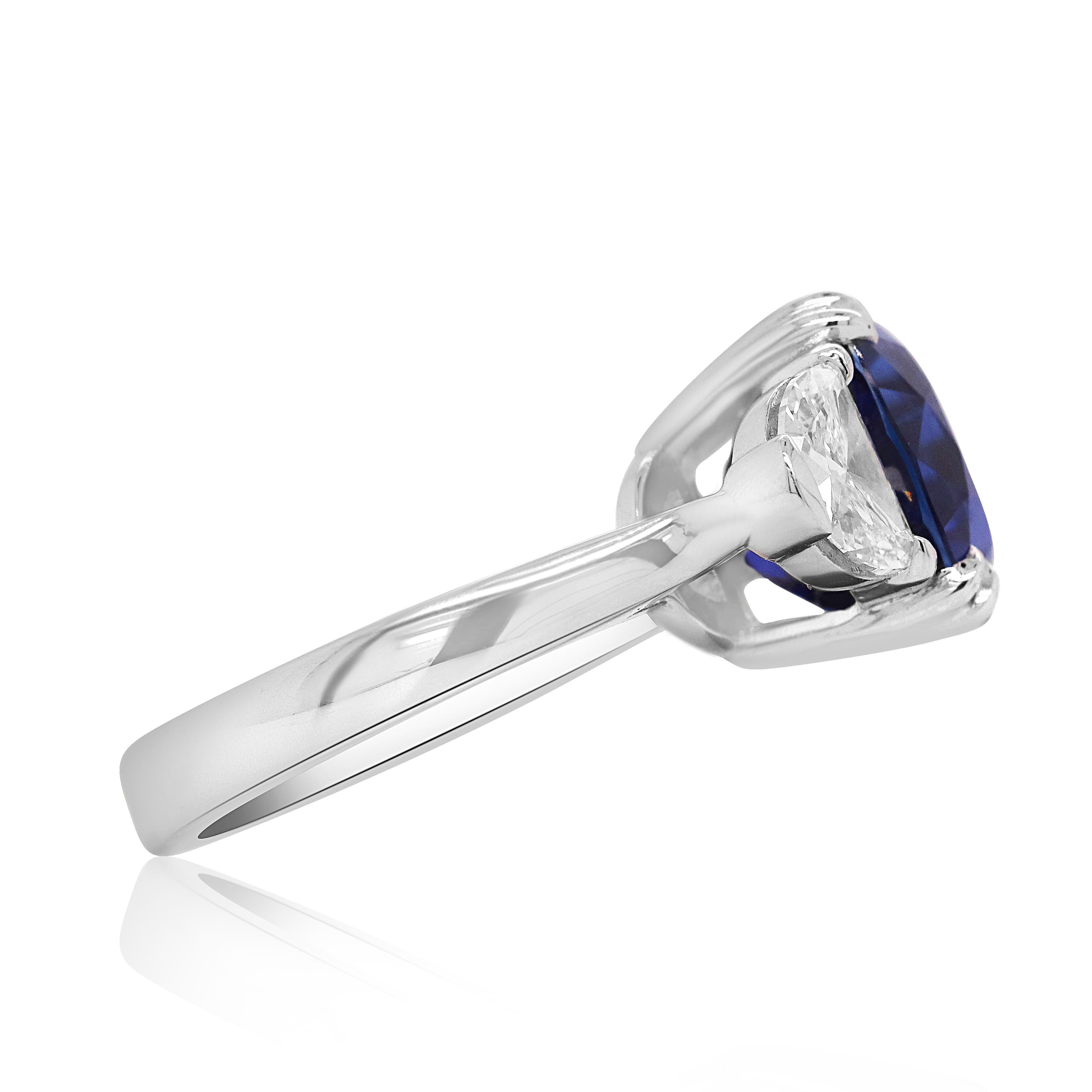 Metal: Platinum 

Center Stone: 1 Cushion Cut Ceylon Blue Sapphire at 8 Carats 

Side Stone Details: 2 Half Moon Diamonds at 1.01 Carats Total Weight 

Ring size: Customizable

Undeniably rare, colorfully bright, and promised to last a lifetime,