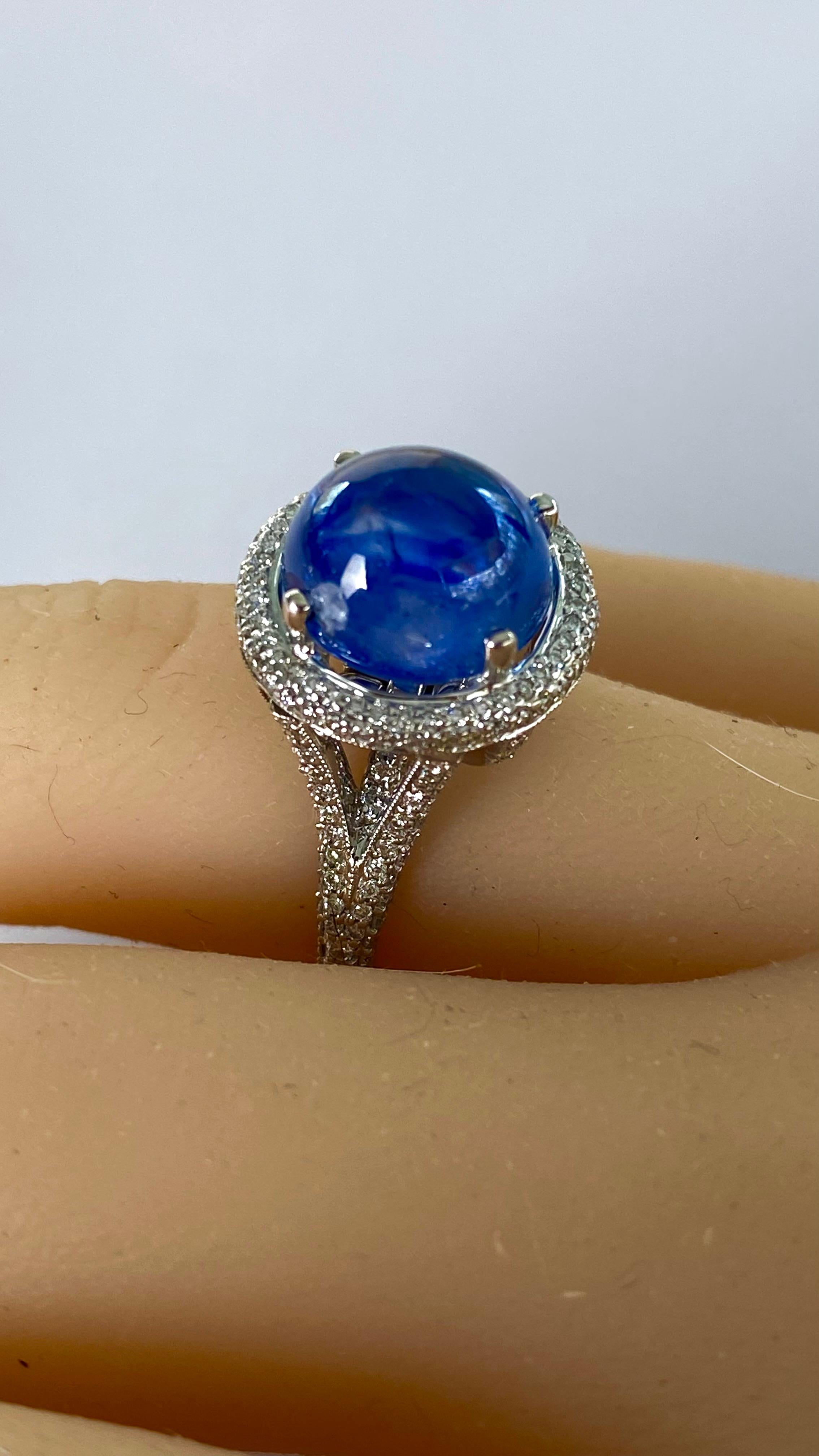 Introducing our exquisite 18 Karat White Gold Vintage Cocktail Ring, a timeless piece that exudes elegance and sophistication. At its heart lies a captivating Ceylon Cabochon Sapphire, weighing a substantial 8.33 carats. This mesmerizing center