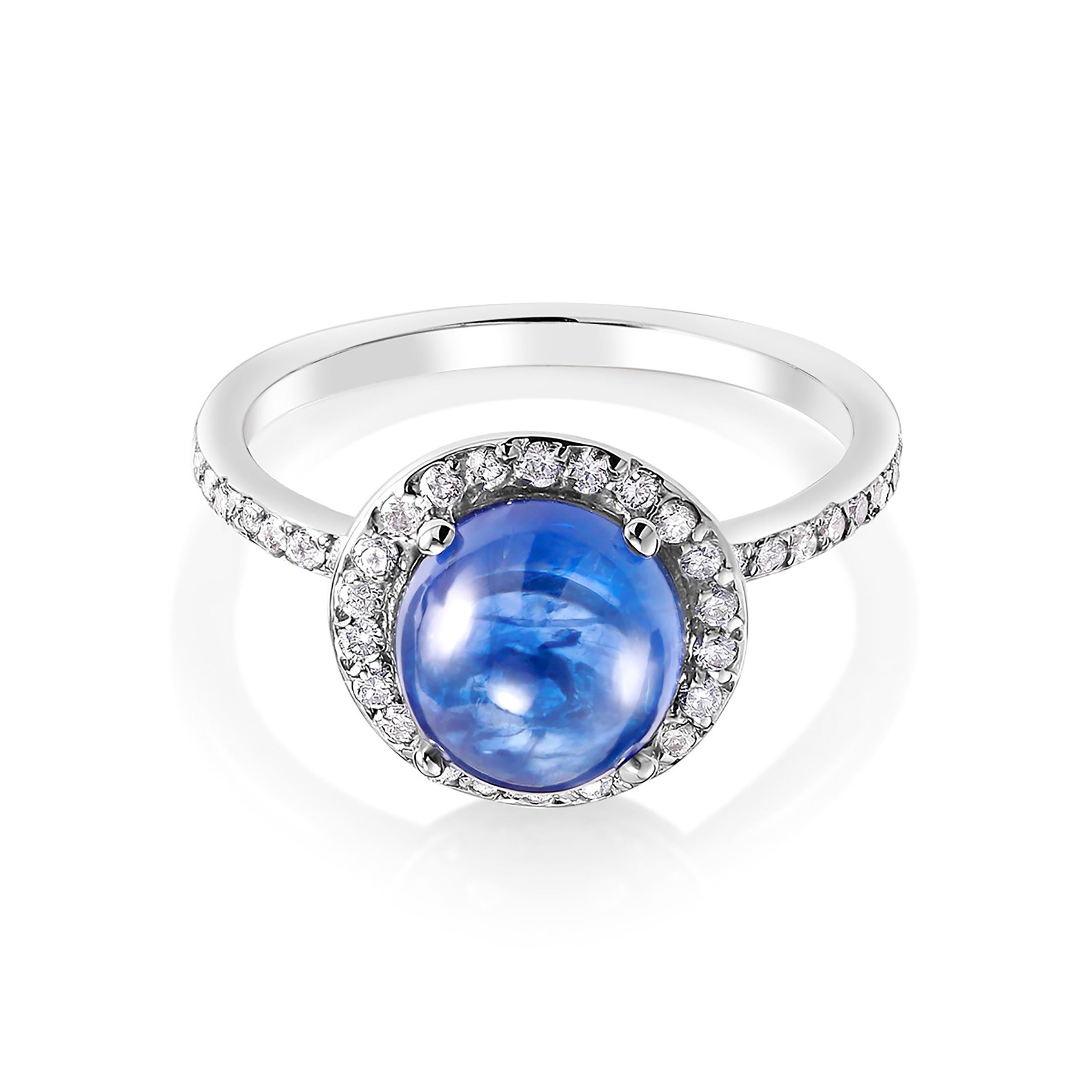 Eighteen karats white gold cluster ring
Ceylon cabochon sapphire weighing 3.60 carat    
Sapphire hue tone color cornflower blue  
Round diamonds weighing 0.60 carat                                                                  
Ring size 6 In