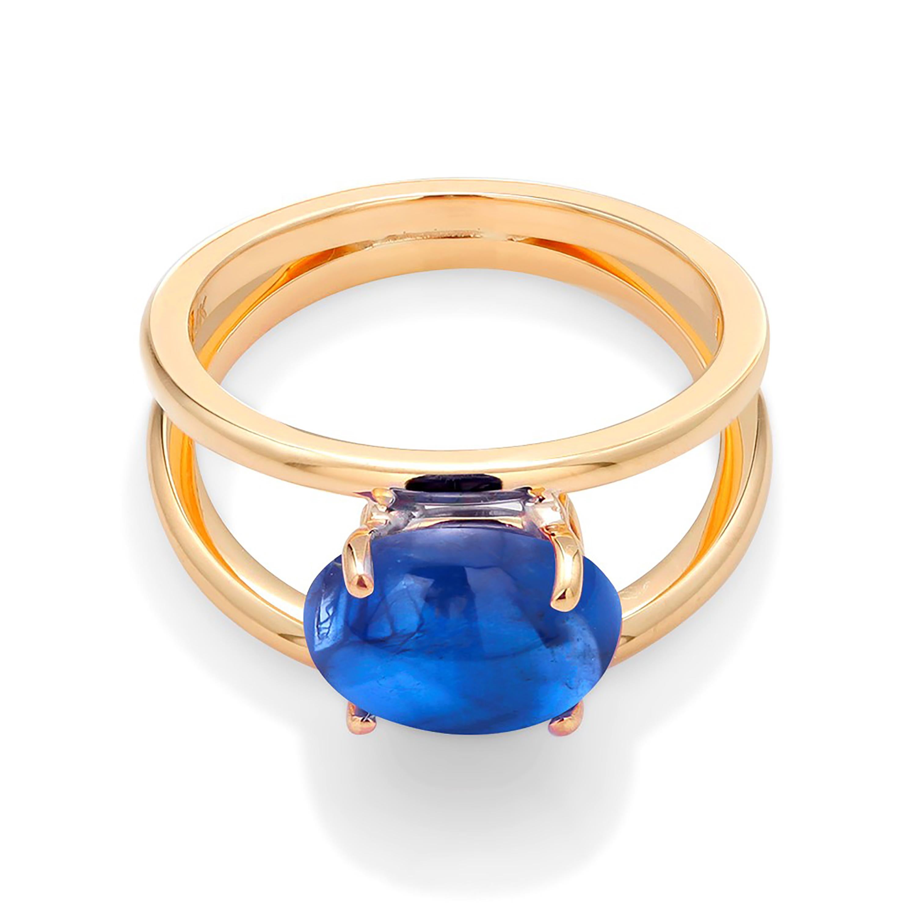 Eighteen karats yellow gold trending split-shank ring 
Split shank ring is a style featuring a band that parts as it reaches the center setting
Ceylon cabochon sapphire weighing 4.04 carat 
Sapphire hue color is royal blue color 
Ring size 5.5 In