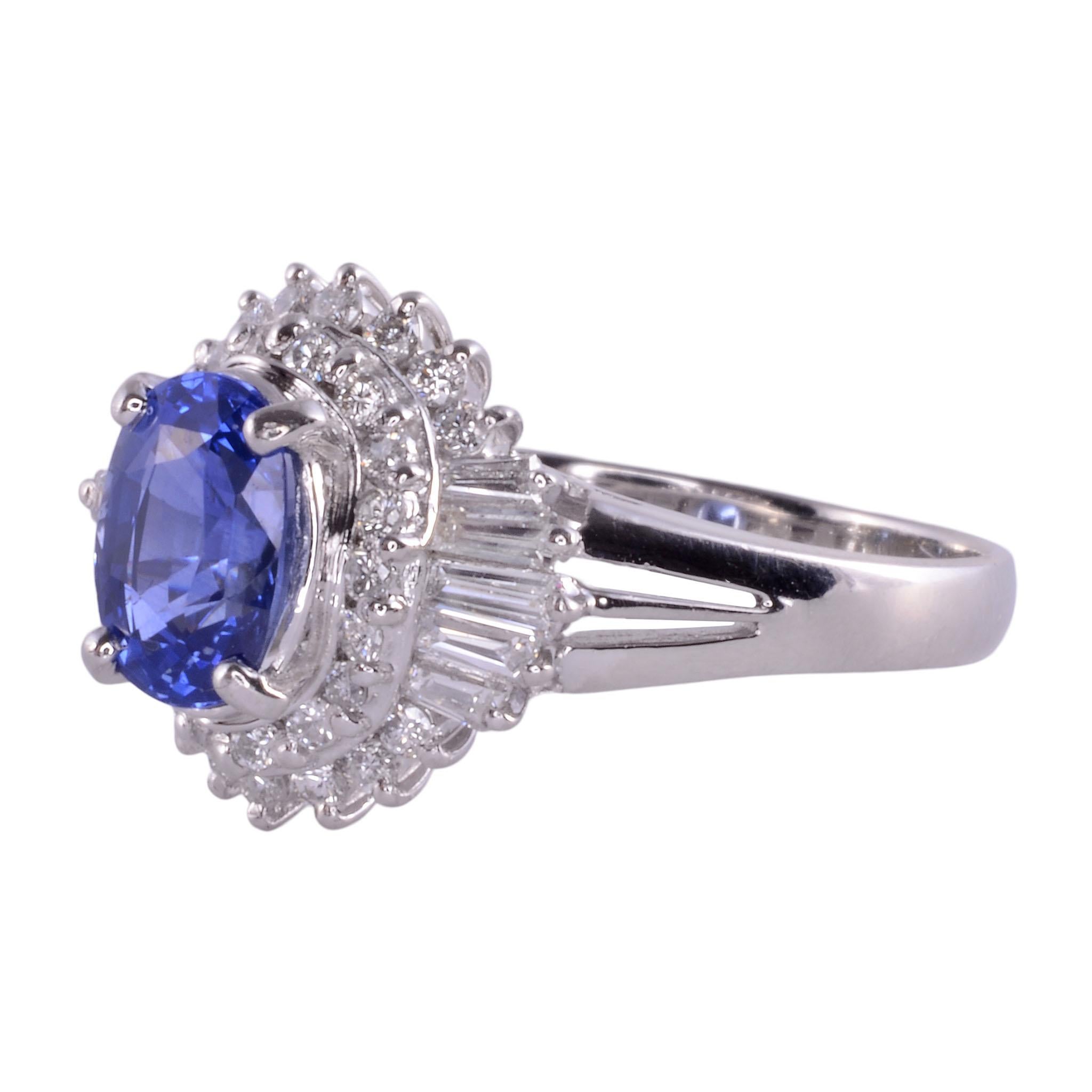 Estate Ceylon color sapphire & diamond platinum ring. This platinum ring features an oval sapphire at 1.58 carats with fine bright medium blue Ceylon color. The sapphire is accented with .06 carat total weight of baguette diamonds with SI clarity