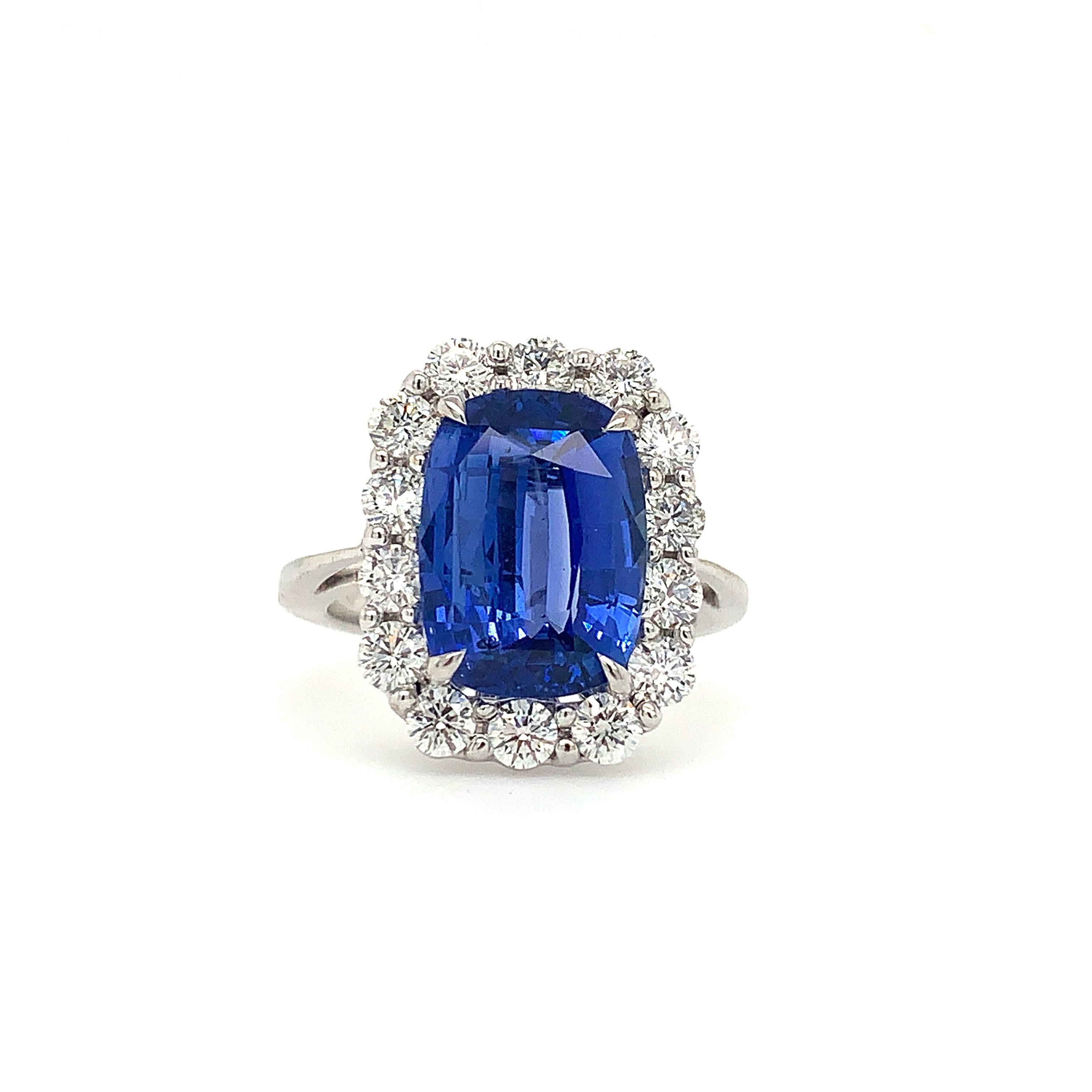 This one-of-a-kind ring features a natural, cushion-cut cornflower blue sapphire gemstone with a diamond halo in an 18K white gold setting. It weighs 6.3 grams and measures 17.5mmx13.4mm at the head, with a 2mm shank. Certified by CD Switzerland
