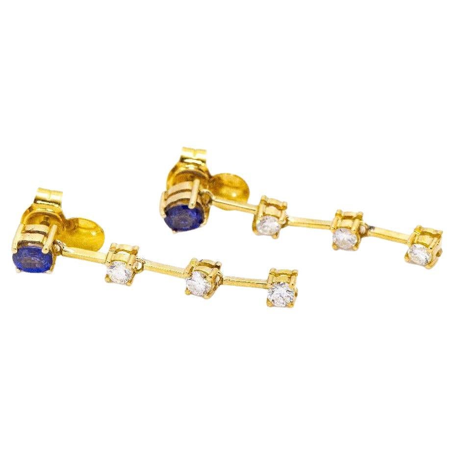 Earrings in Yellow Gold for woman  6x Brilliant Cut Diamonds with total weight approx. 0,19ct in H/VS quality and 2x Oval Cut Sapphires 5x4mm  Pressure closing  18kt Yellow Gold  4,50 grams.  Sizes: Length 3,5cm  Brand New Item  Ref.:D360286JE