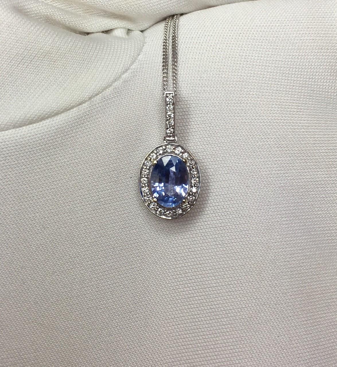 Stunning natural light blue Ceylon sapphire set in a fine 18k white gold diamond cluster pendant.

1.14 carat centre sapphire with a beautiful light blue colour and excellent clarity.

Beautiful Ceylon (Sri Lankan) stone.

The pendant is hanging on