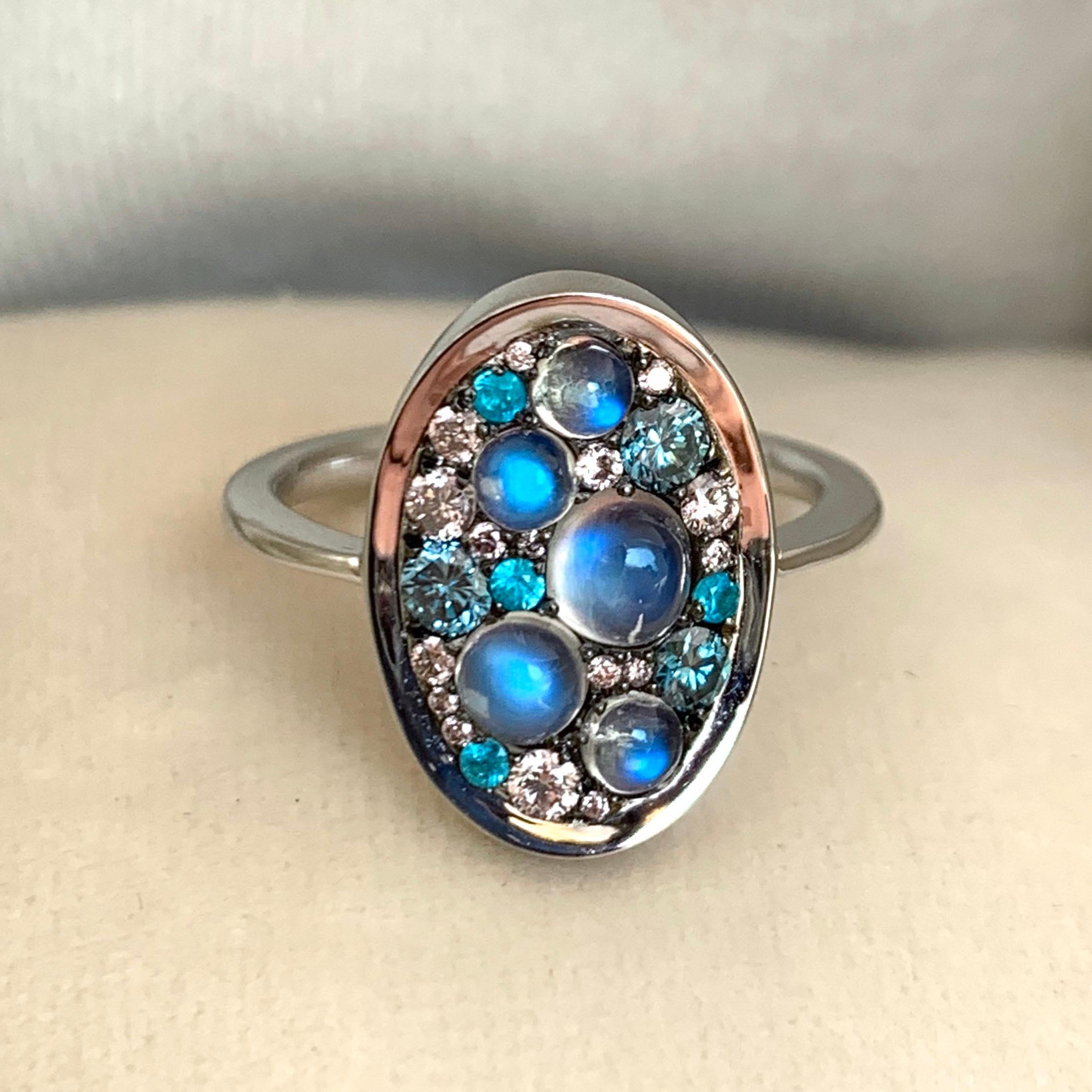 One of a kind ring in 18K White gold 4,9g & blackened sterling silver (The stones are set on blackened sterlingsilver to create a black background for the stones) Pave set with Ceylon Moonstone cabochons 1,1 ct., Fancy Pink diamonds, natural colored