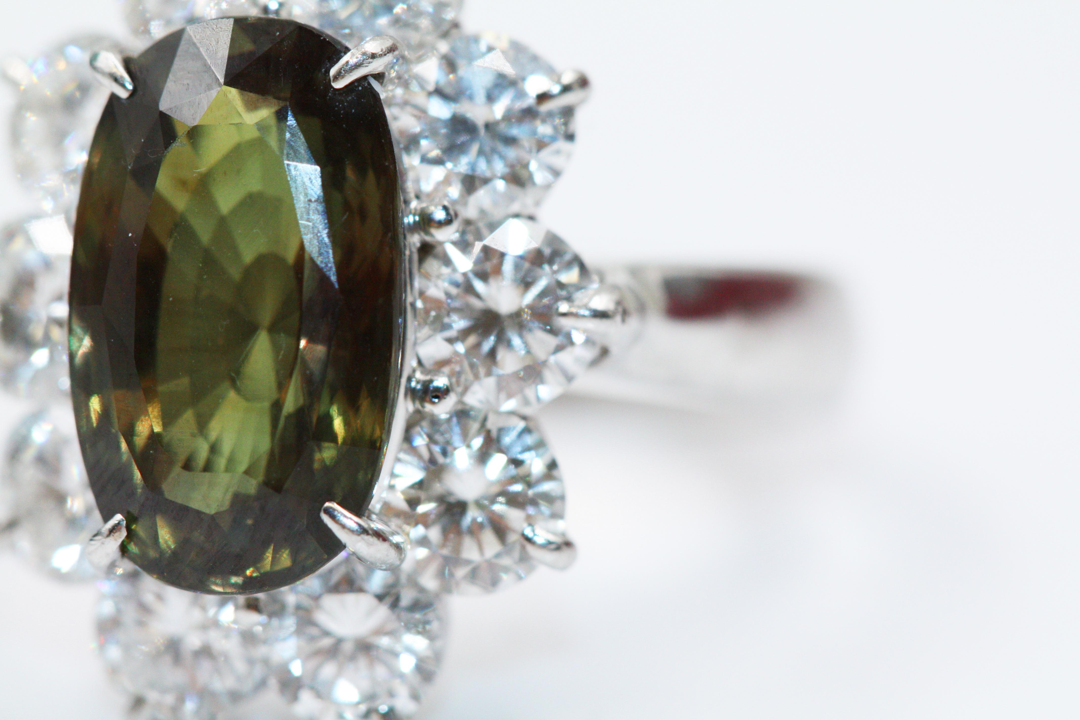 Ceylon Natural Chrysoberyl Alexandrite Stone Diamond 18K White Gold Ring 5.27 cts

Set in a white metal ring with several round diamonds (identified at random). 
Degree of Color Change: Moderate (50% ~ 60%)
Quality of Color Change: Good
Provenance: